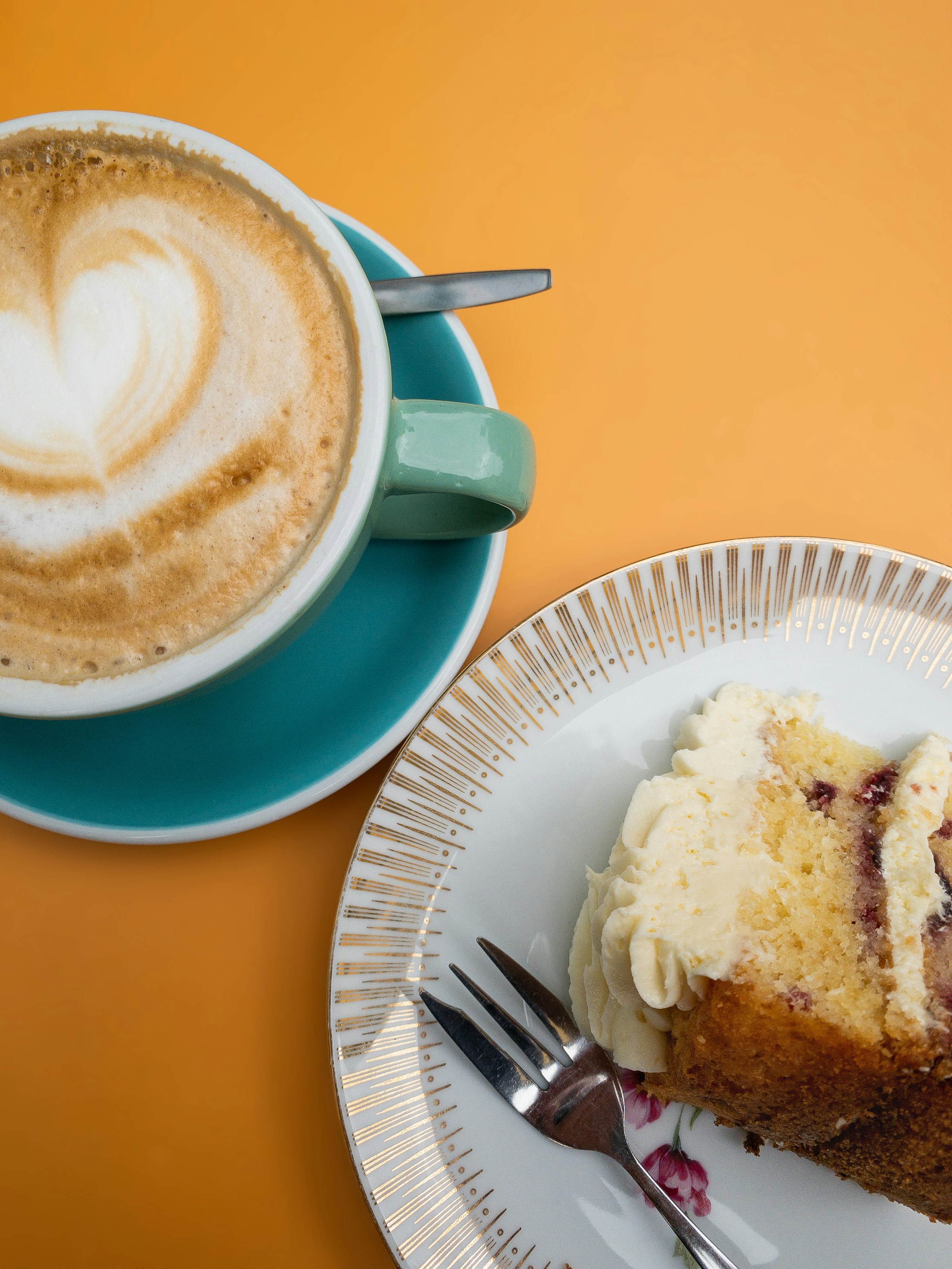 A cup of coffee and a slice of cake | Source: Unsplash