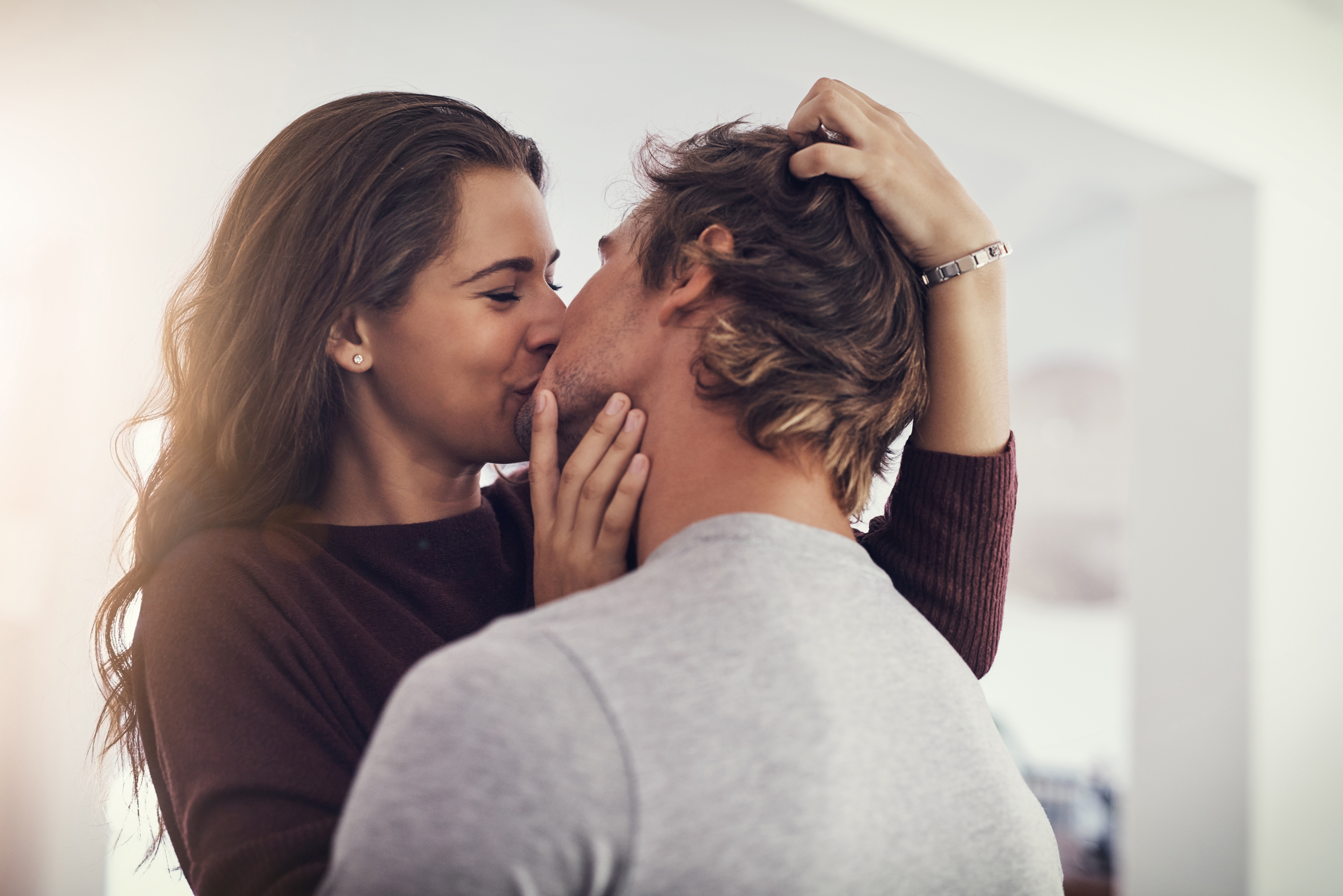 Woman kissing man | Shutterstock