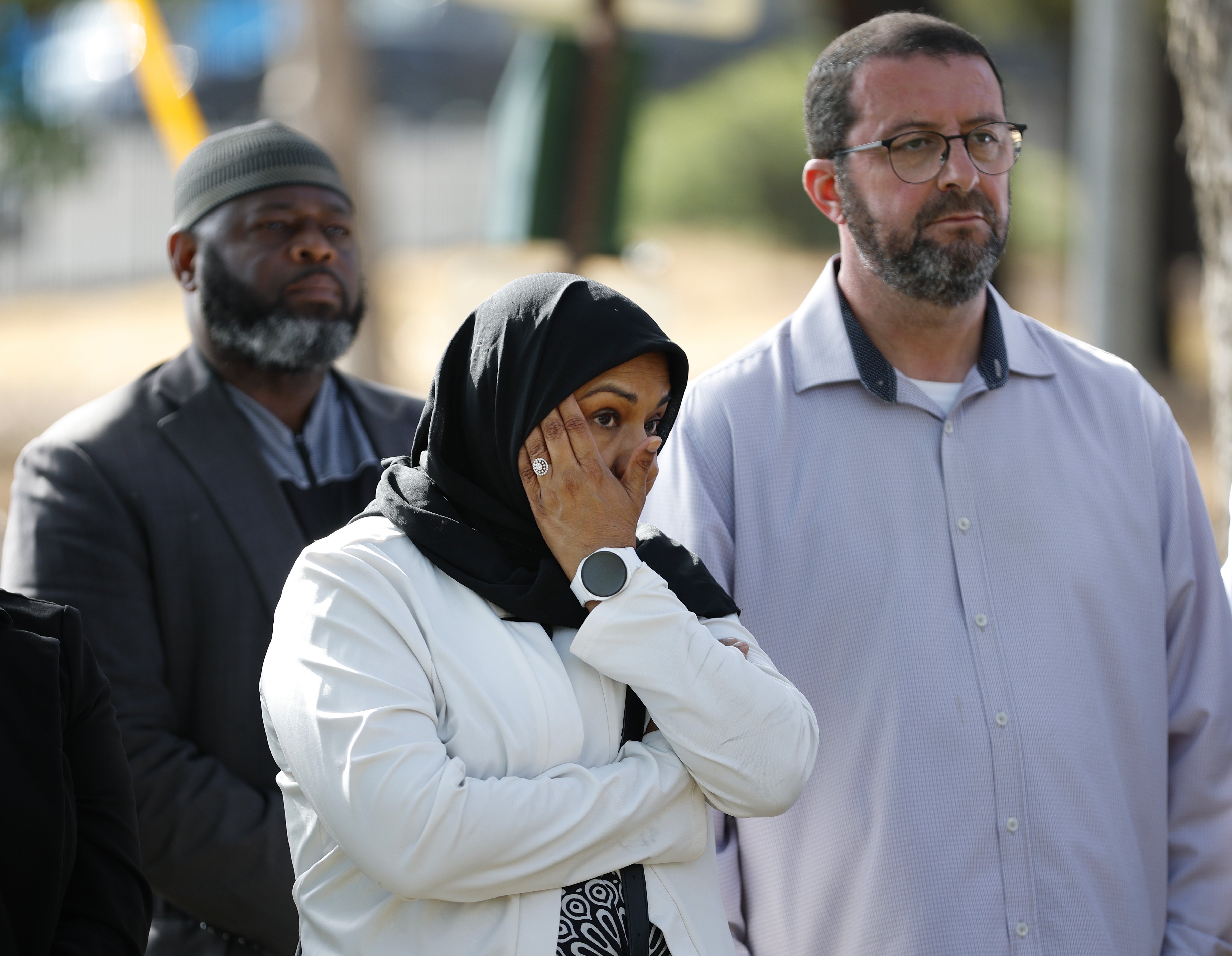 Tazheen Nizam of San Diego Council on American-Islamic Relations (CAIR) and Islamic Center of San Diego's director and imam Taha Hassane listen during a news conference after a shooting at the Islamic Center of San Diego on May 18, 2026, in San Diego, California | Source: Getty Images