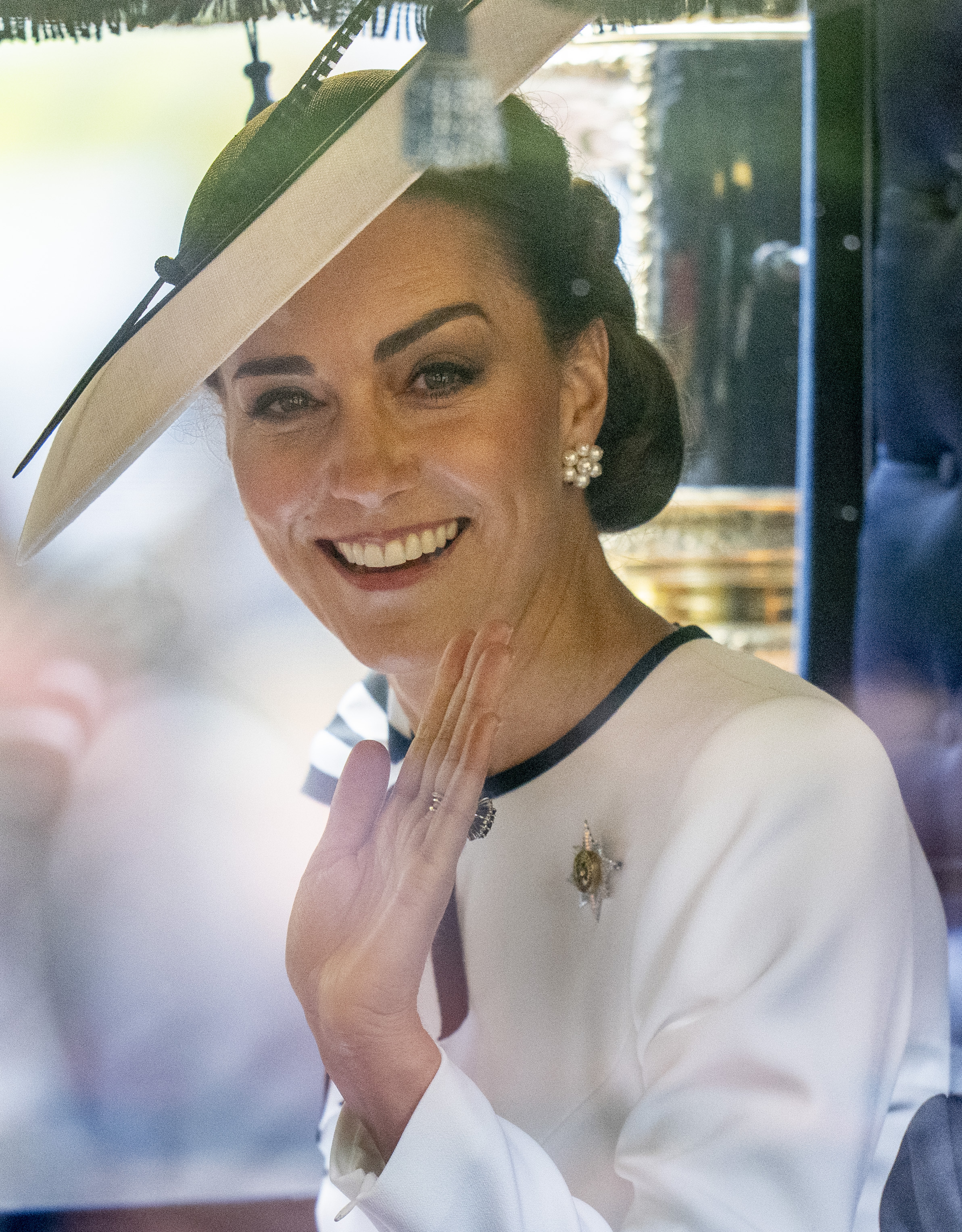 Kate Middleton warmly waves to spectators during Trooping the Colour, effortlessly blending regal tradition with the approachable charm that has made her one of the royal family's most beloved figures.