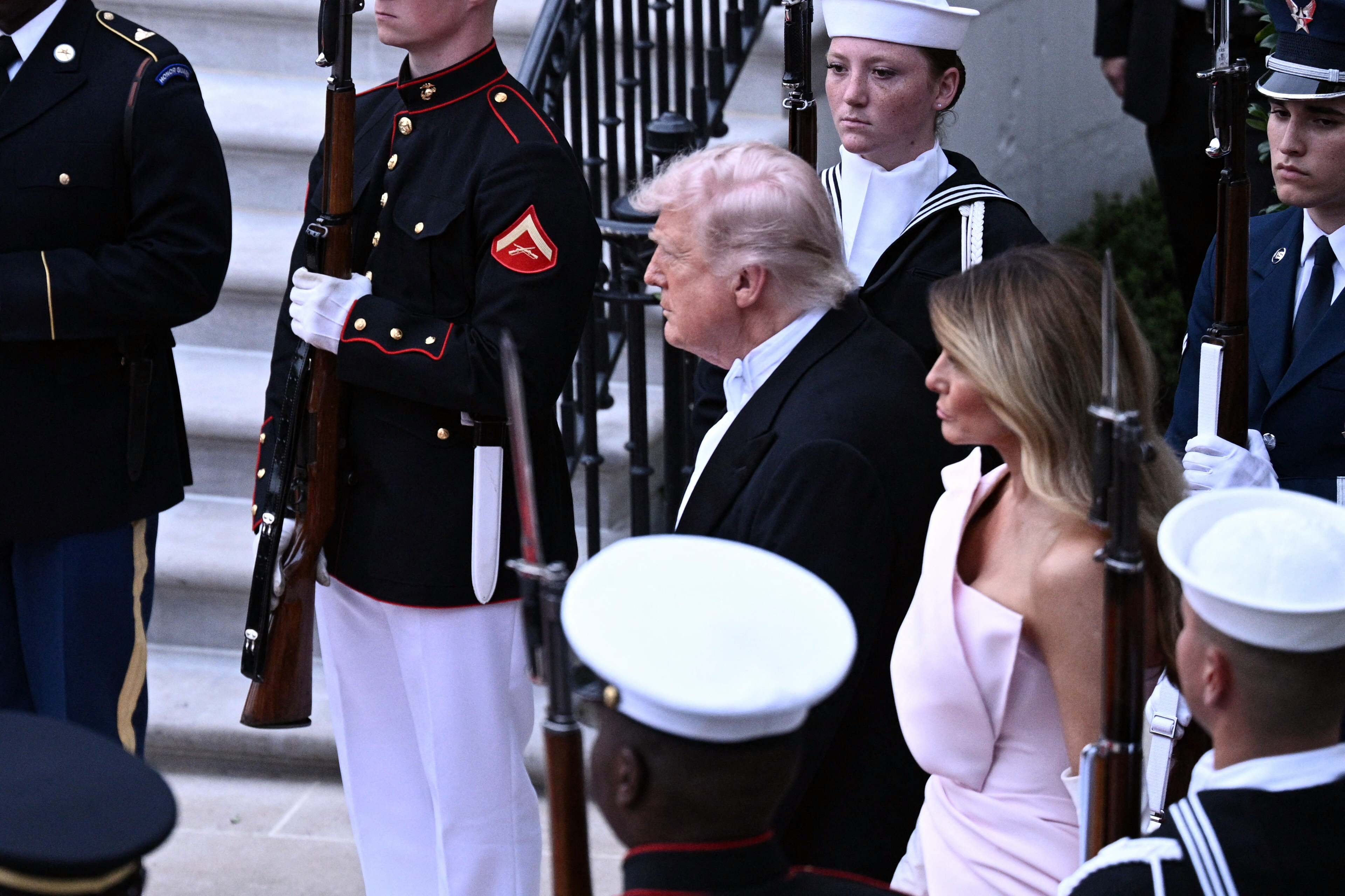 Donald Trump and Melania Trump stand ready as King Charles III and Queen Camilla arrive for a State Dinner in the White House East Room, April 28, 2026. | Source: Getty Images