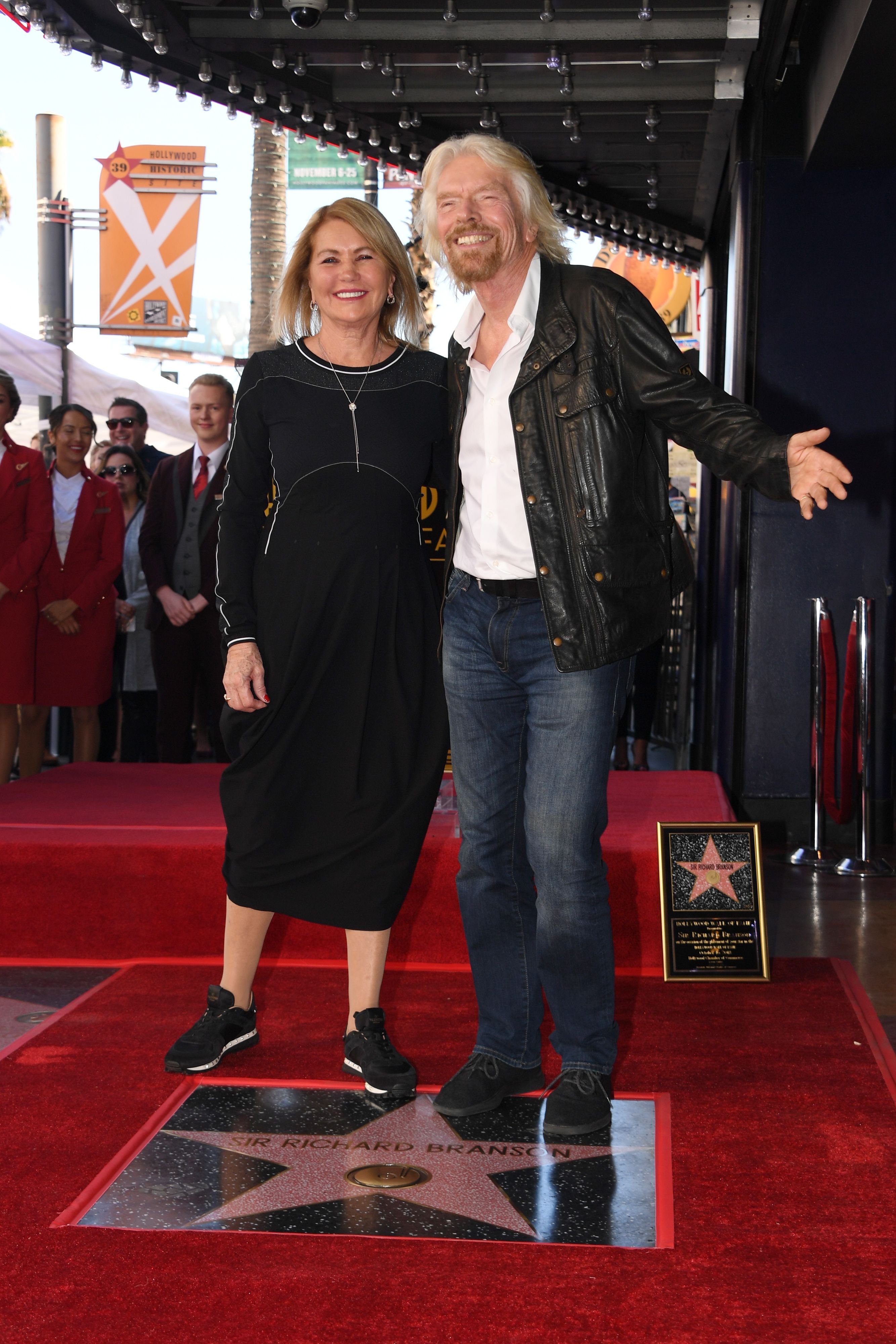 Richard Branson poses Joan Templeman on his star at his Hollywood Walk of Fame star unveiling ceremony, on October 16, 2018 in Hollywood, California | Source: Getty Images