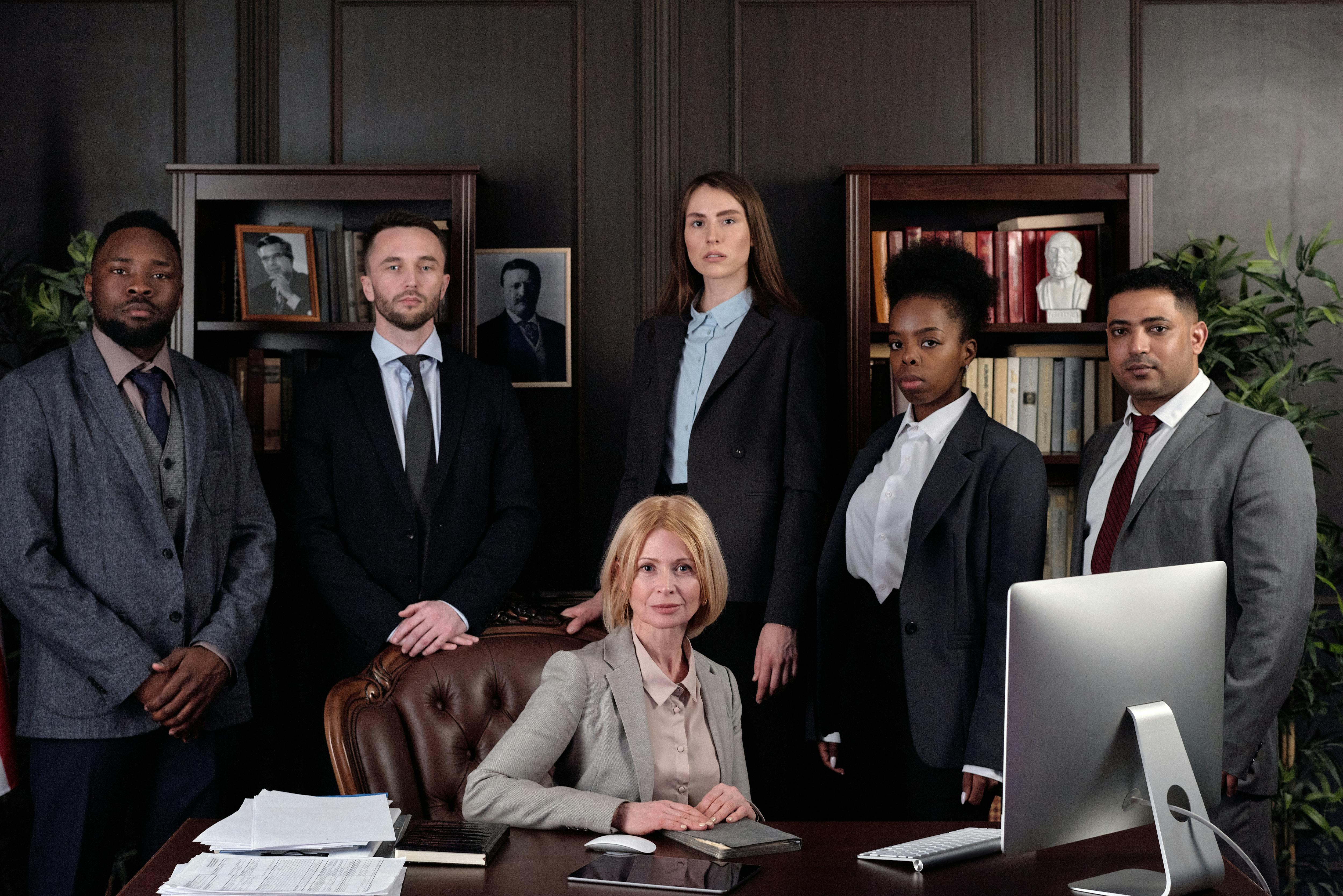 Lawyers posing by a desk | Source: Pexels