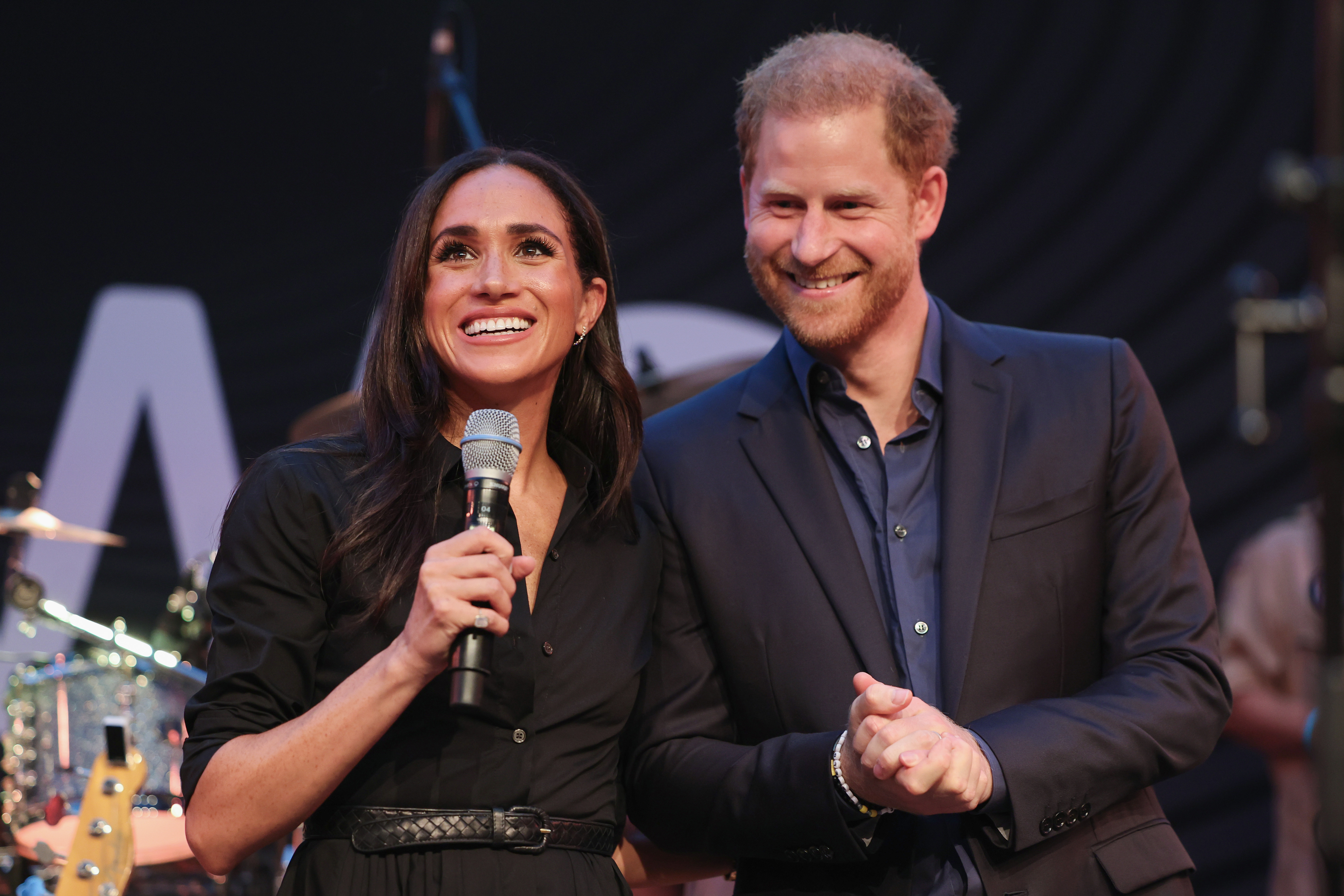 Meghan Markle and Prince Harry on stage at the "Friends @ Home Event" during day three of the Invictus Games in Düsseldorf, Germany on September 12, 2023. | Source: Getty Images