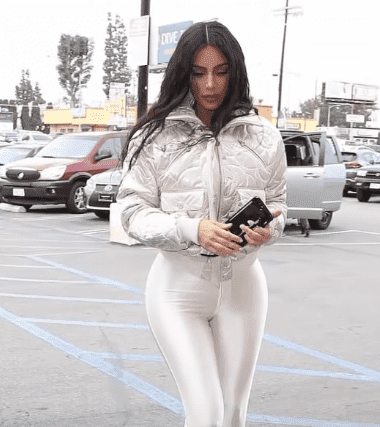 Kim Kardashian wearing Shiny White Leggings and Puffer Jacket While in Calabasas.| Photo: YouTube/ Celebrity News.