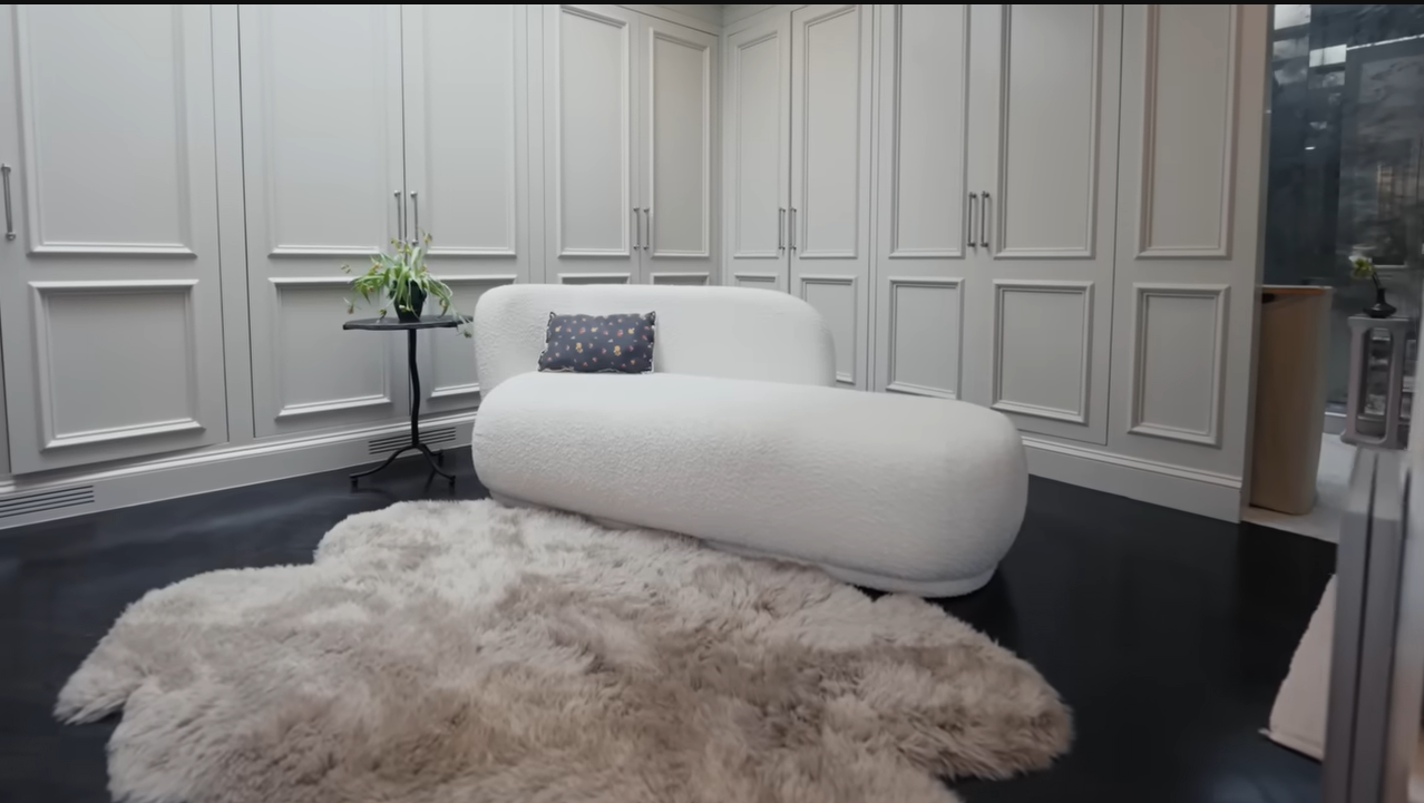 This ultra-chic white chaise lounge and plush sheepskin rug perfectly capture Palmer's vision of a glamorous, retro boudoir. | Source: YouTube/@Archdigest