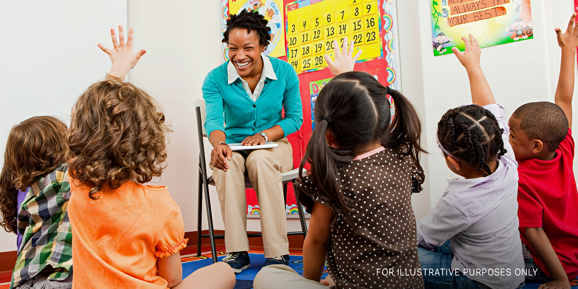 A teacher smiling at her students | Source: Shutterstock