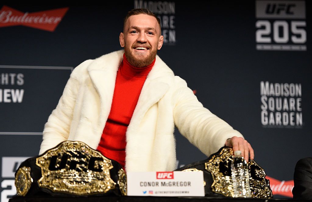 Conor McGregor showing off his Featherweight and Lightweight championship belts during the UFC 205 press conference at Madison Square Garden on November 10, 2016 | Photo: Getty Images