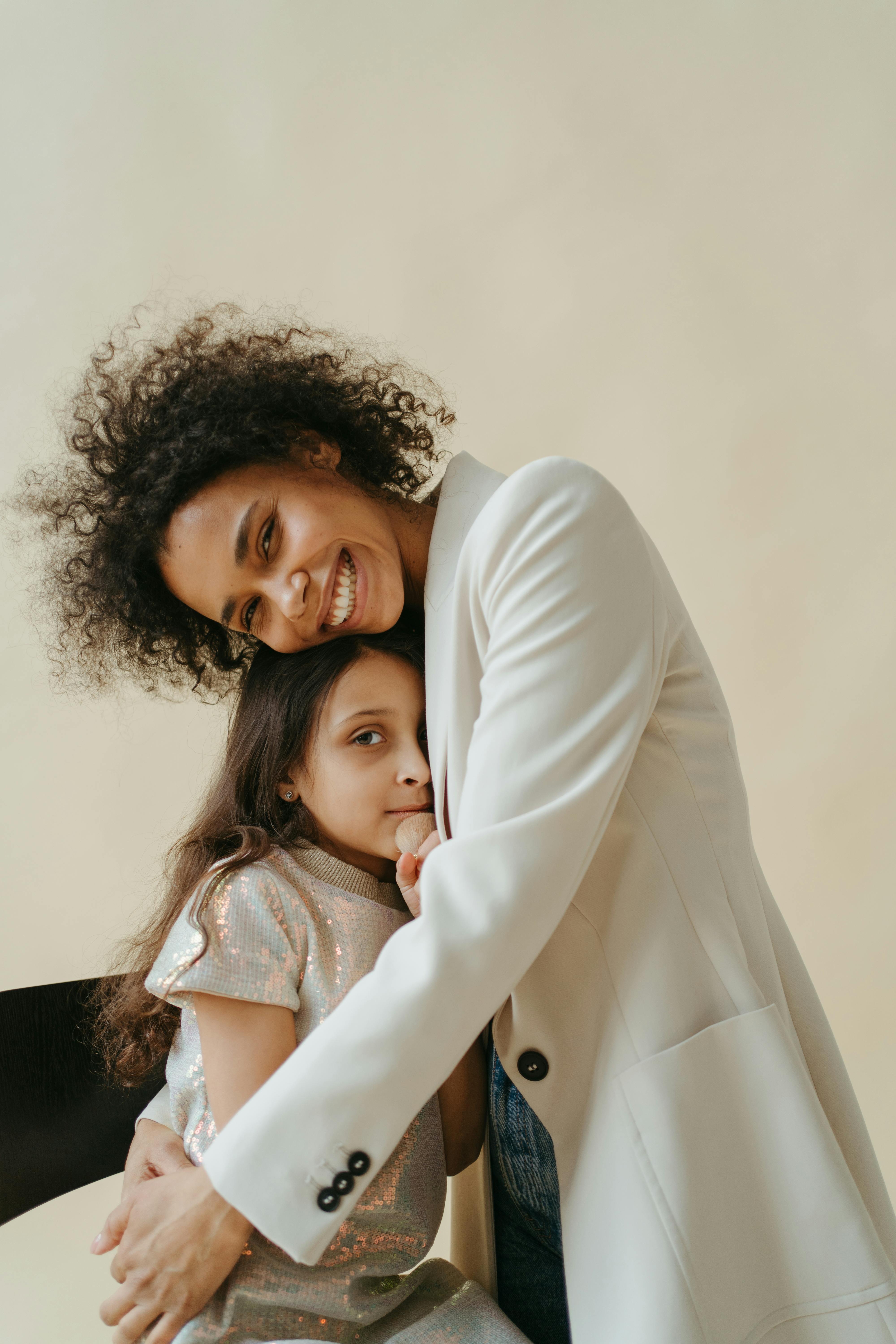 A woman embracing her daughter | Source: Pexels