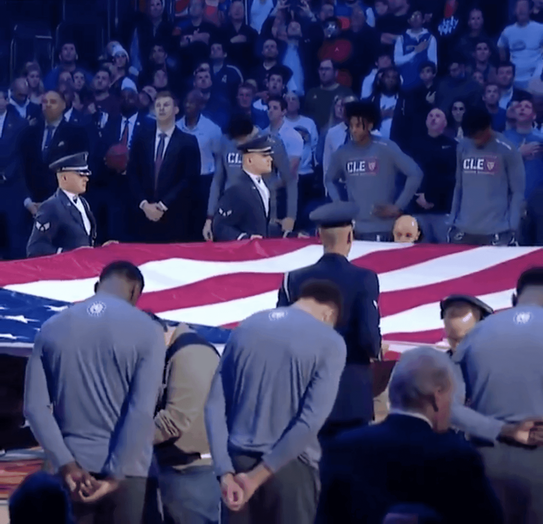 Players and military personnel standing in honor of the national anthem. | Source: Twitter/espn