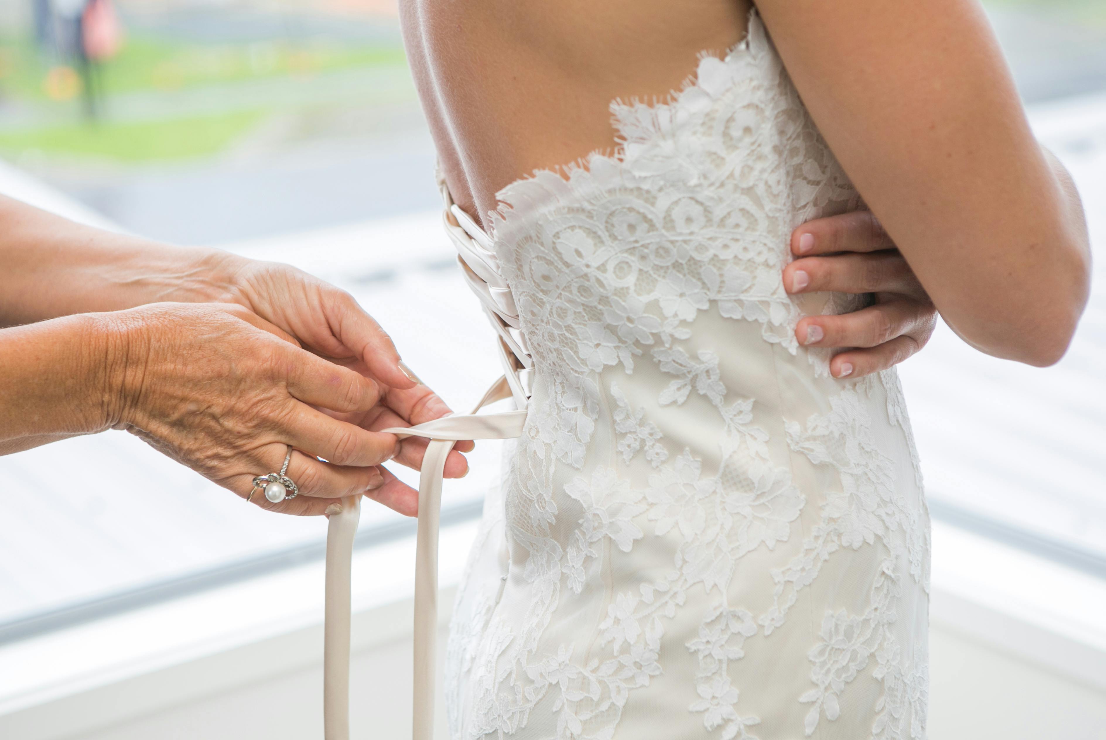 An older woman helps another undress | Source: Pexels