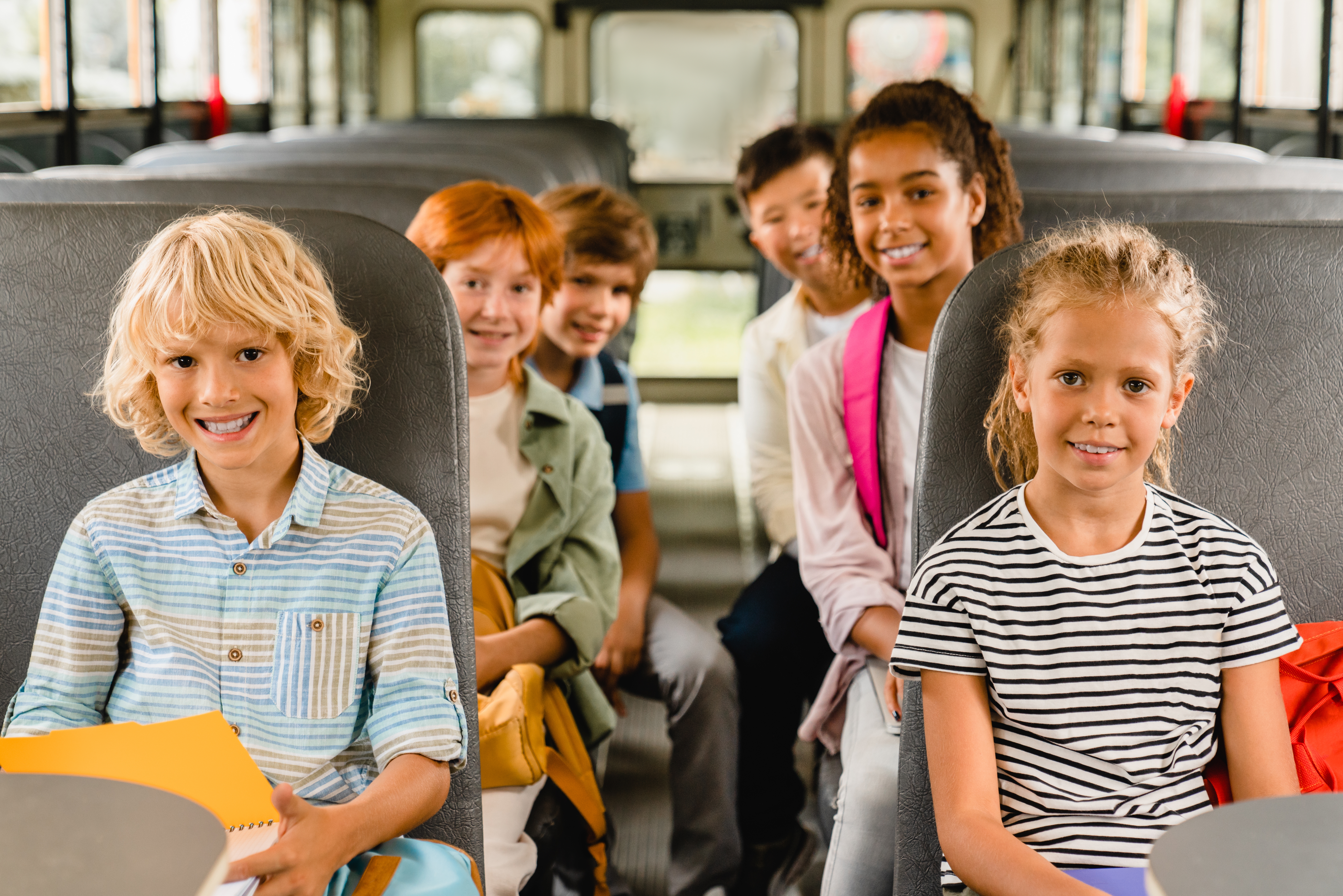 Children sitting inside a school bus | Source: Shutterstock