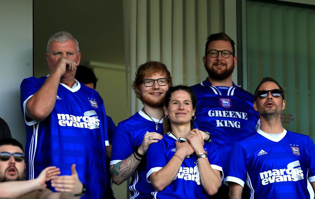 Ed Sheeran and Cherry Seaborn look on during the Sky Bet Championship match between Ipswich Town and Aston Villa at Portman Road on April 21, 2018 in Ipswich, England. | Source: Getty Images