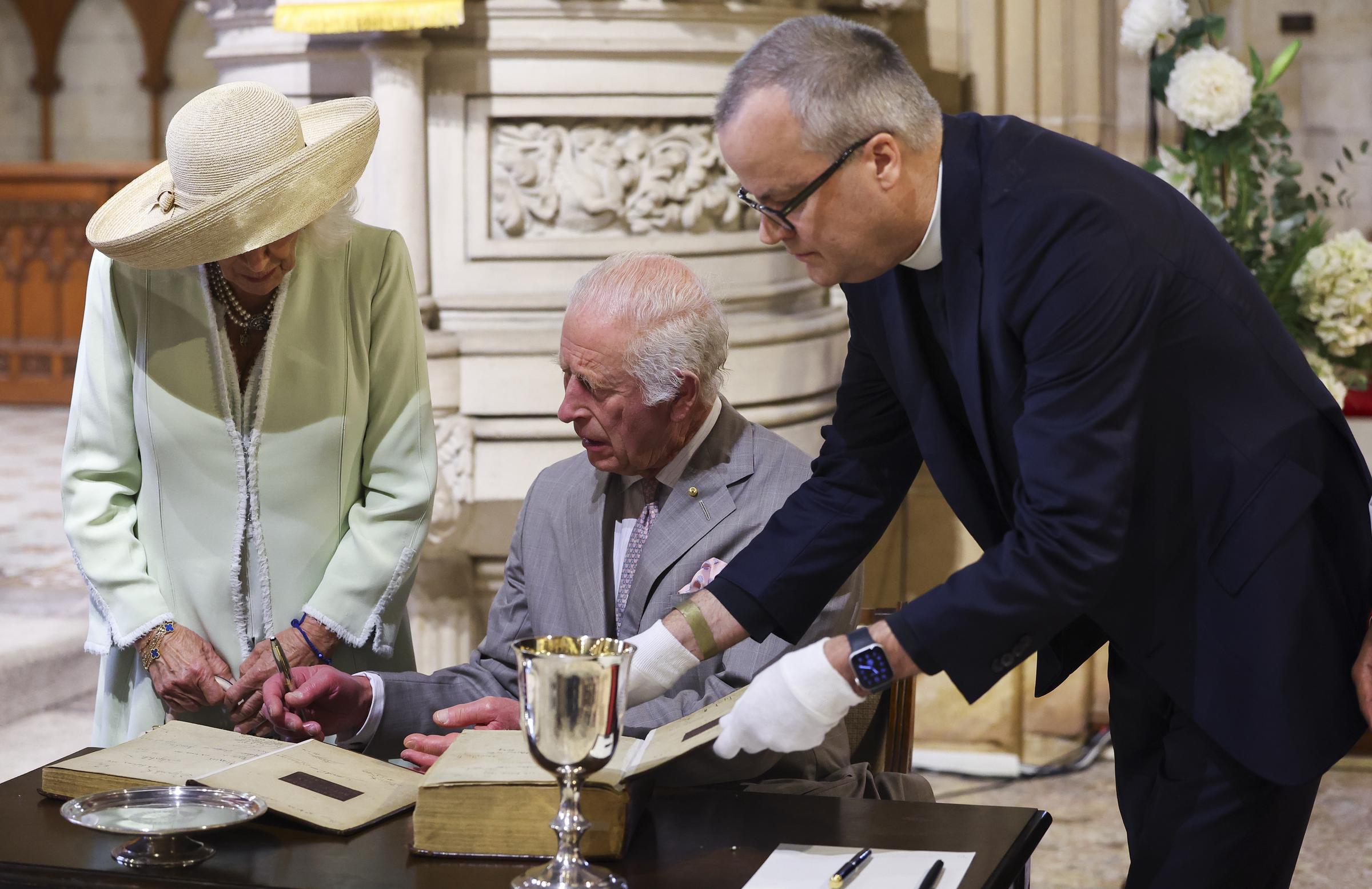 King Charles III and Queen Camilla look at the Book of Common Prayer during a visit to St. Thomas's Anglican Church on October 20, 2024, in Sydney, Australia. | Source: Getty Images