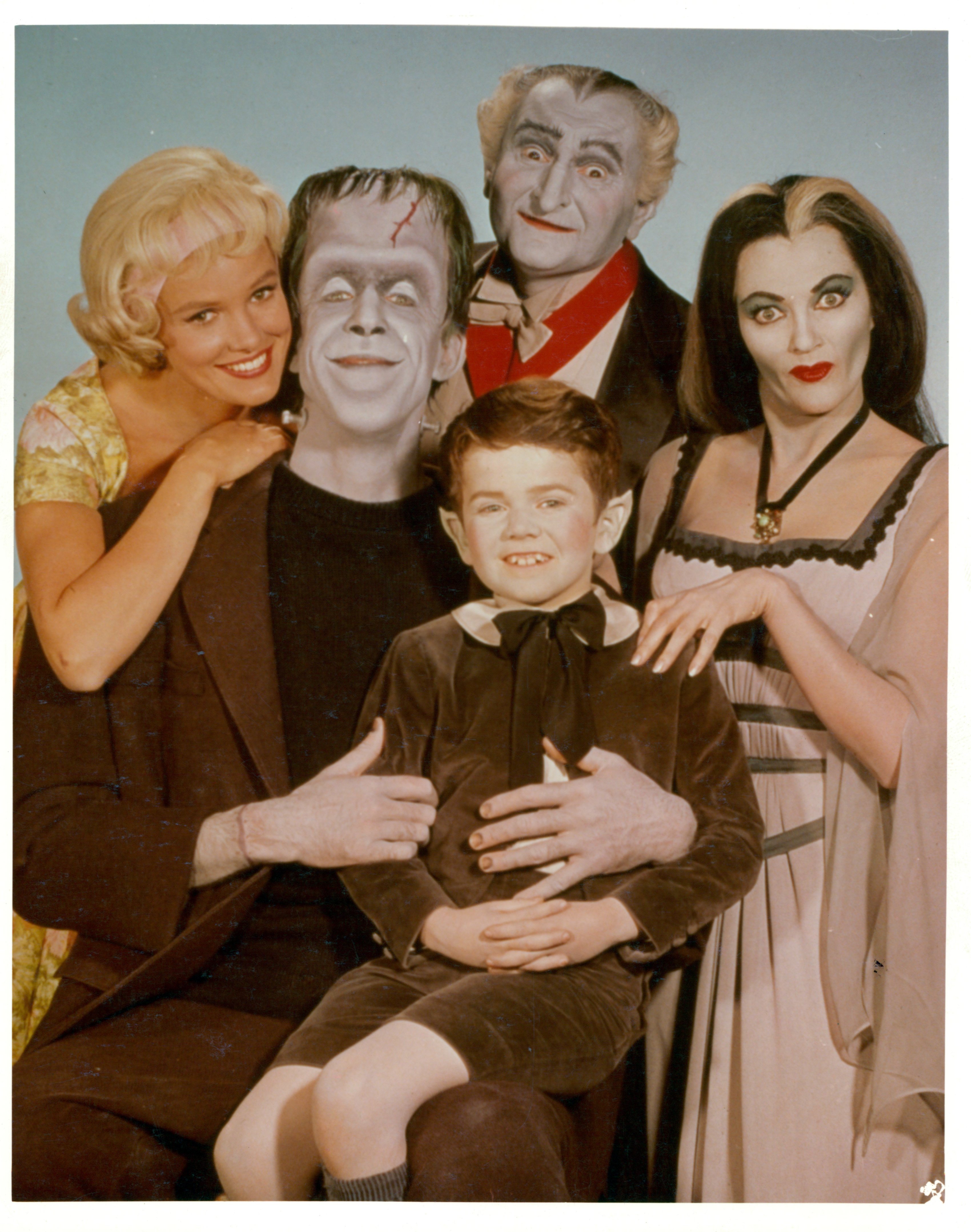 Pat Priest, Al Lewis and Butch Patrick along with Fred Gwynne and Yvonne De Carlo of the Munster family in a publicity photograph from the television series 'The Munsters', circa 1964. I Source: Getty Images