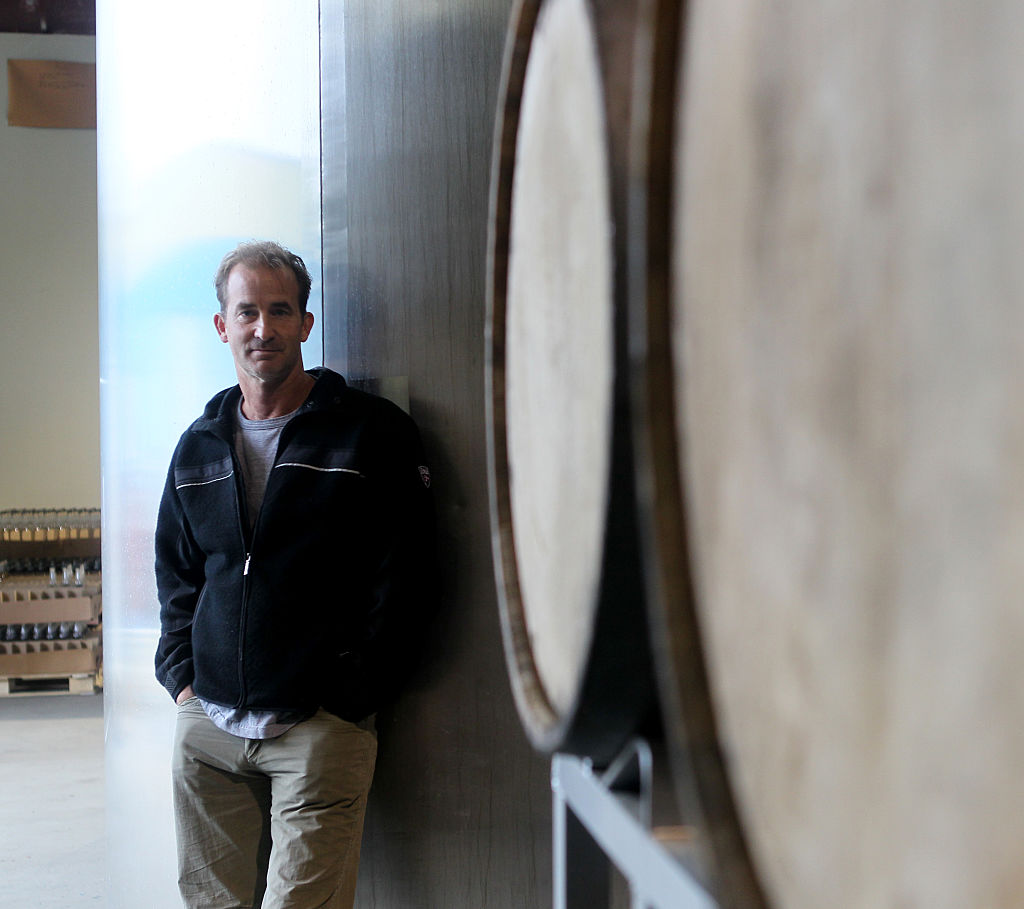 Andrew Cabot beside a 2,000-gallon fermenter in Ipswich, Massachusetts, on October 1, 2014 | Source: Getty Images