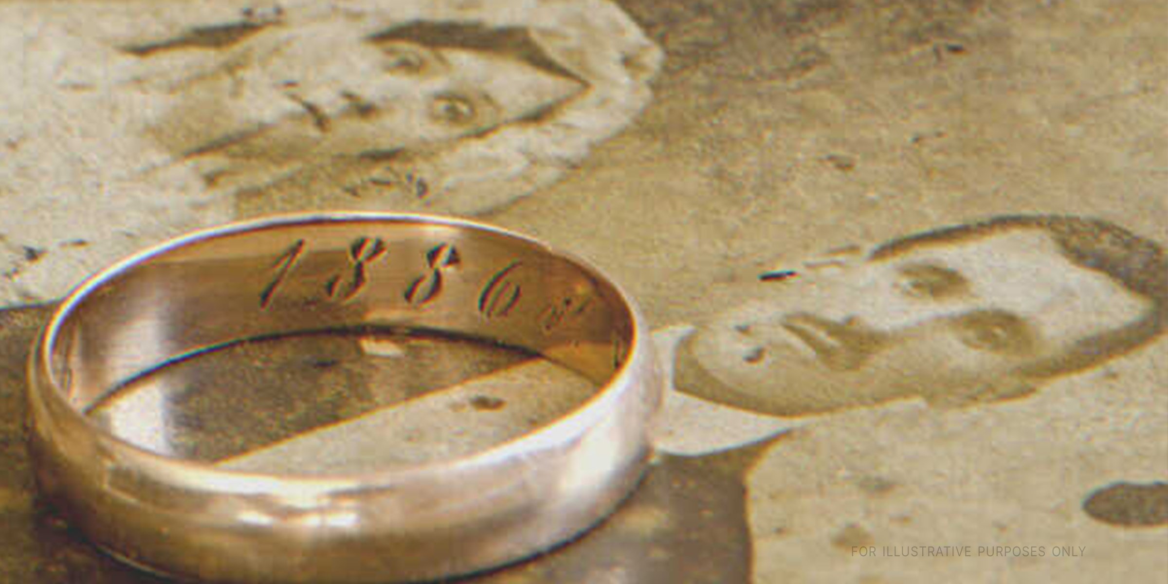 An inscribed wedding band on an old photograph | Source: Shutterstock