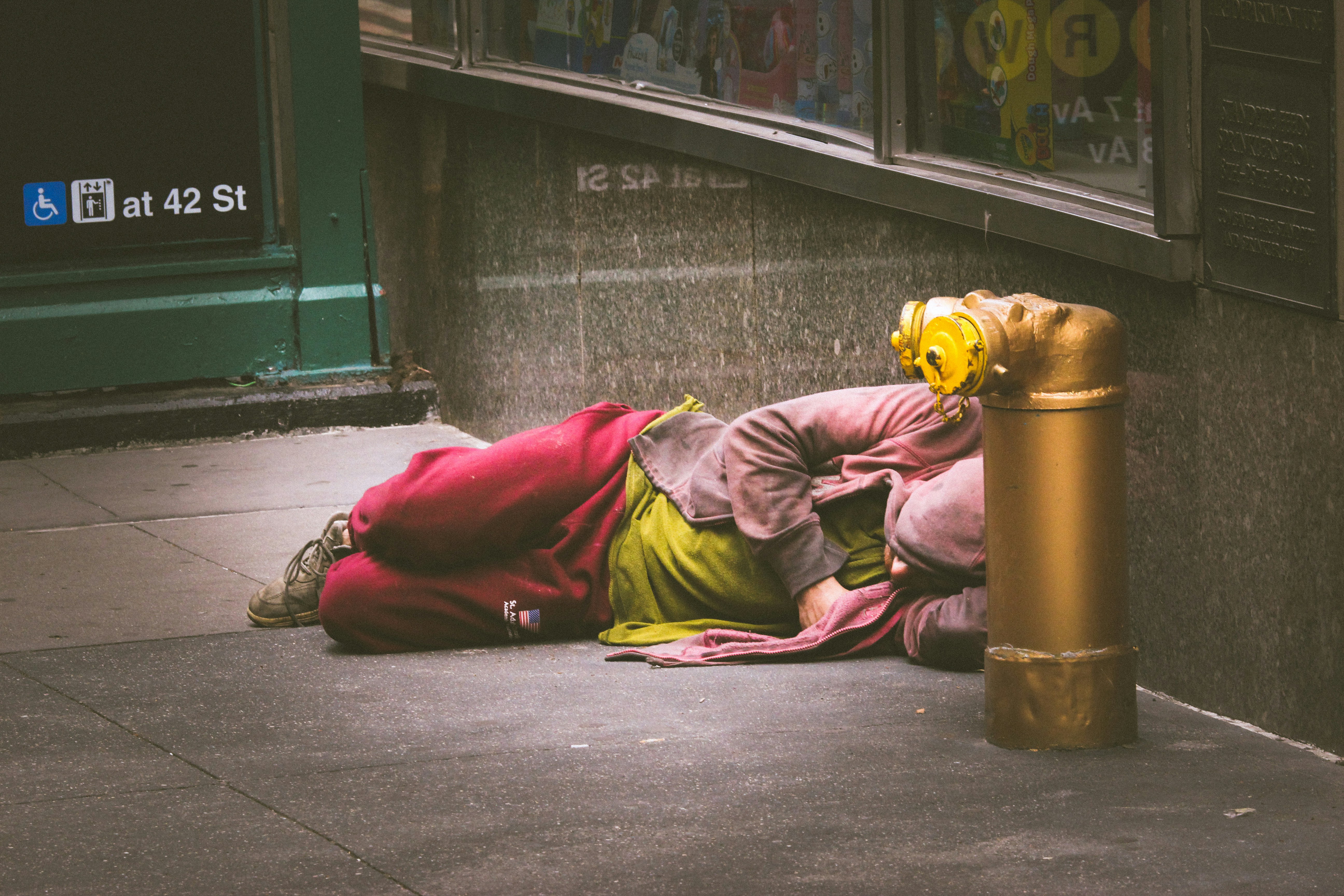 A homeless person sleeping on the floor | Source: Unsplash