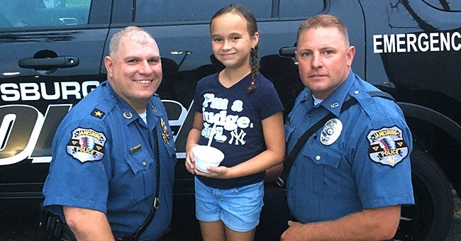Mikayla Raji with two police officers | Photo: facebook.com/Jamesburgpolice