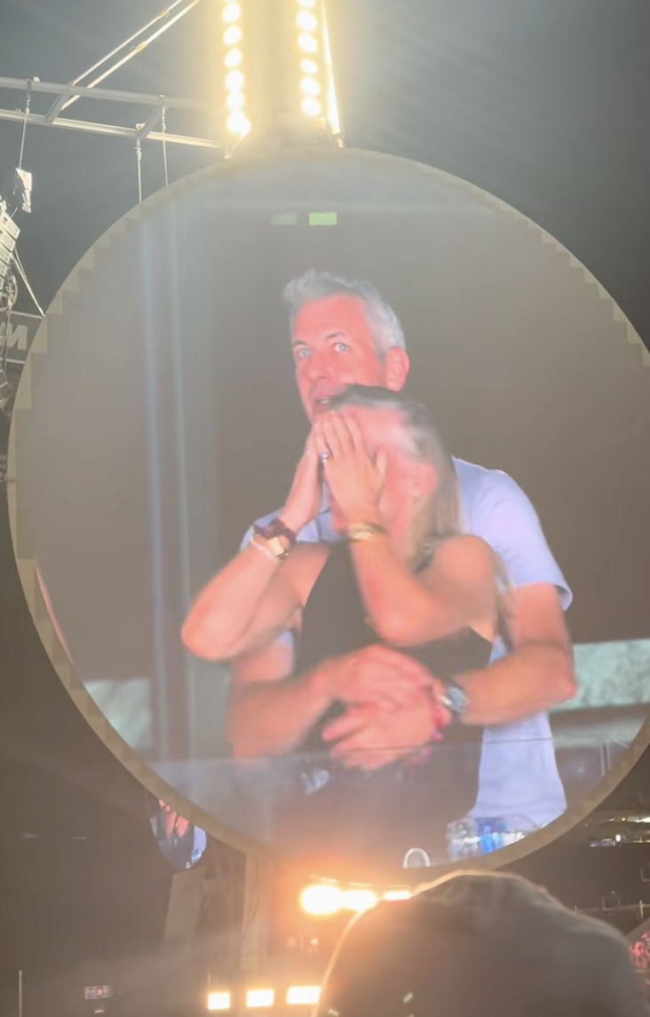 Kristin Cabot hides her face as she discovers herself on the big screen with Astronomer CEO Andy Byron during Coldplay's Boston concert on July 16, 2025 | Source: TikTok/@instaagraace