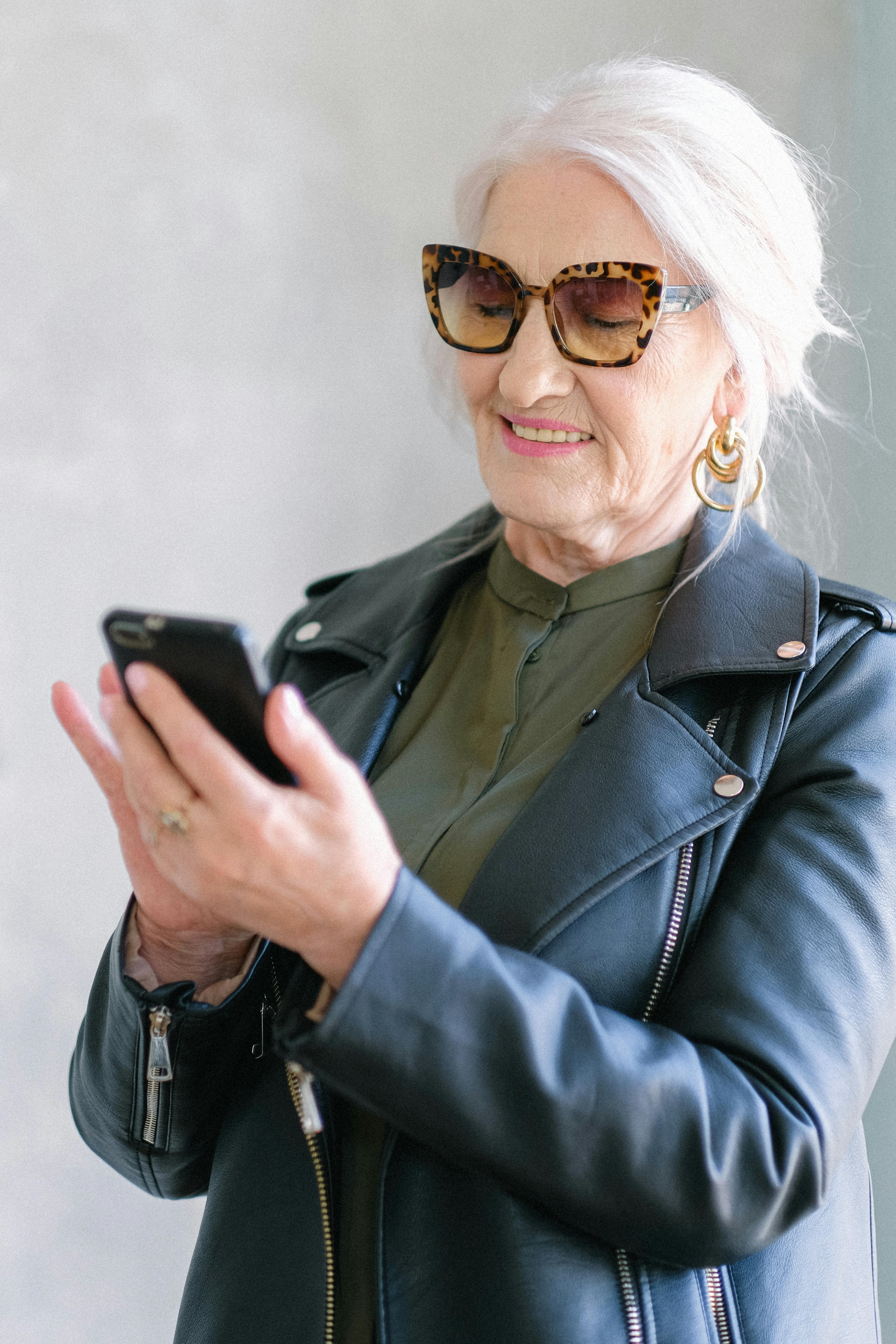 A content senior woman hanging up the phone | Source: Pexels