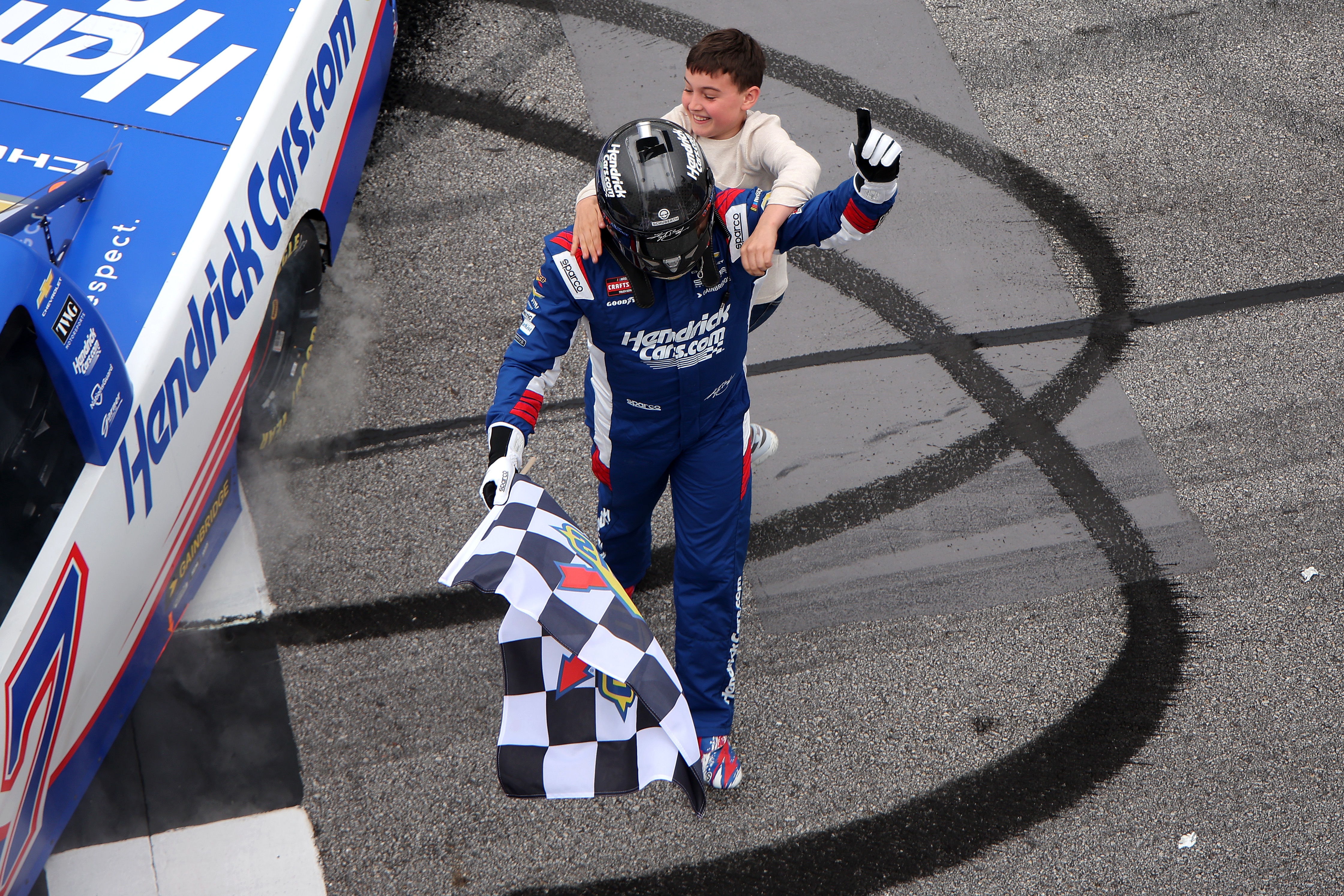 Brexton Busch congratulating his dad, Kyle Busch, after Kyle won the NASCAR Craftsman Truck Series Fr8 Racing 208 in Hampton, Georgia on February 21, 2026. | Source: Getty Images