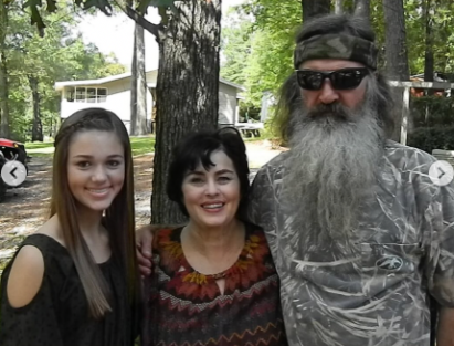 Sadie posing with Katy and Phil Robertson, dated May 2025 | Source: instagram/legitsadierob