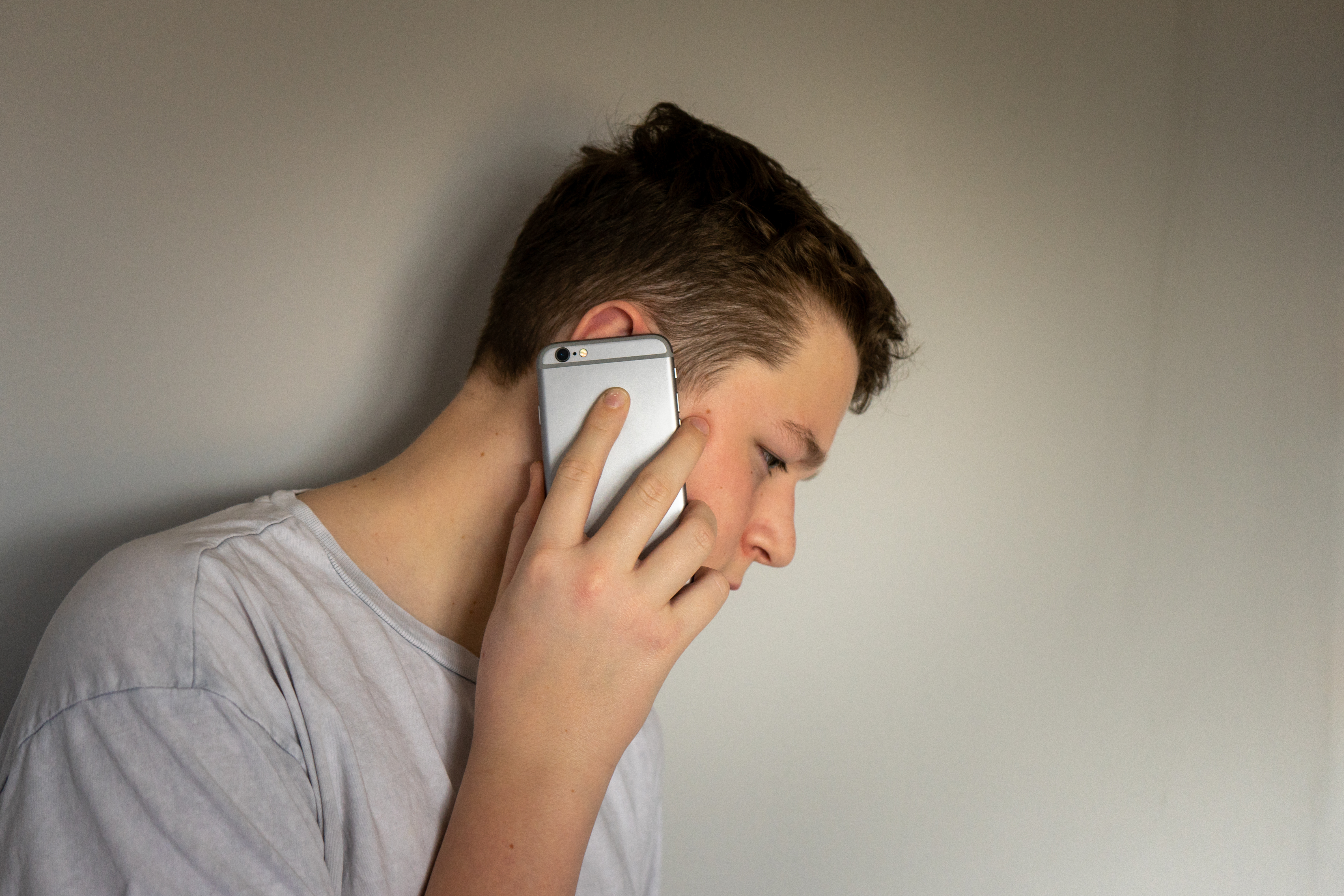 Teenage boy talking on the phone | Source: Shutterstock