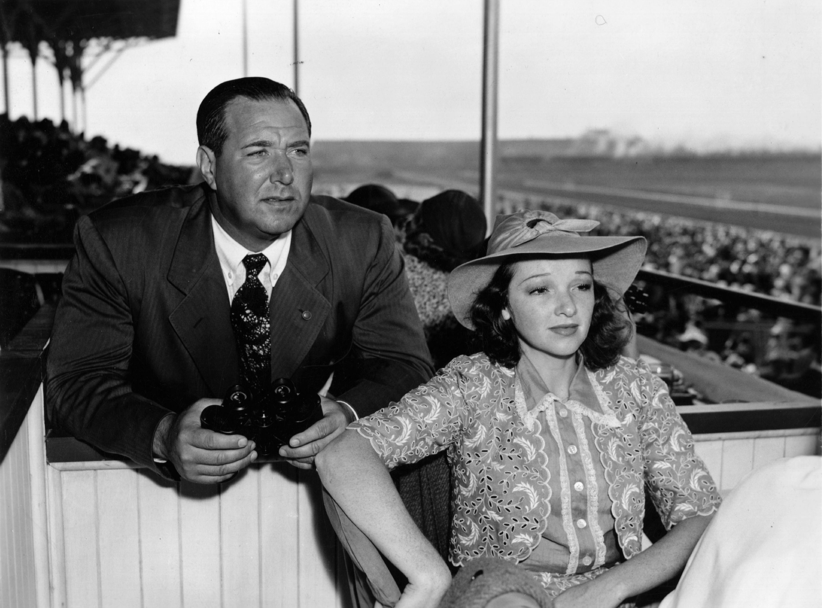 Director Dave Butler and Dixie Lee Crosby pictured watching a race in 1940. | Photo: Getty Images