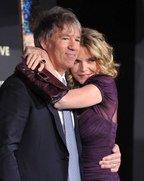 David E. Kelley and Michelle Pfeiffer arrive to the Premiere Of Warner Bros. Pictures' "New Year's Eve" on December 5, 2011, in Hollywood, California. | Source: Getty Images.