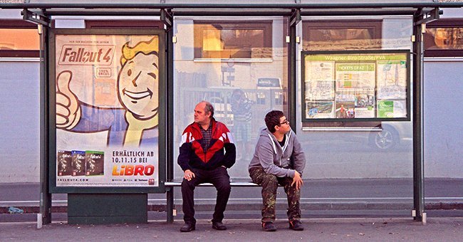 A man with a stutter conversing with another man at a bus station | Photo: Shutterstock A man with a stutter conversing with another man at a bus station | Photo: Shutterstock
