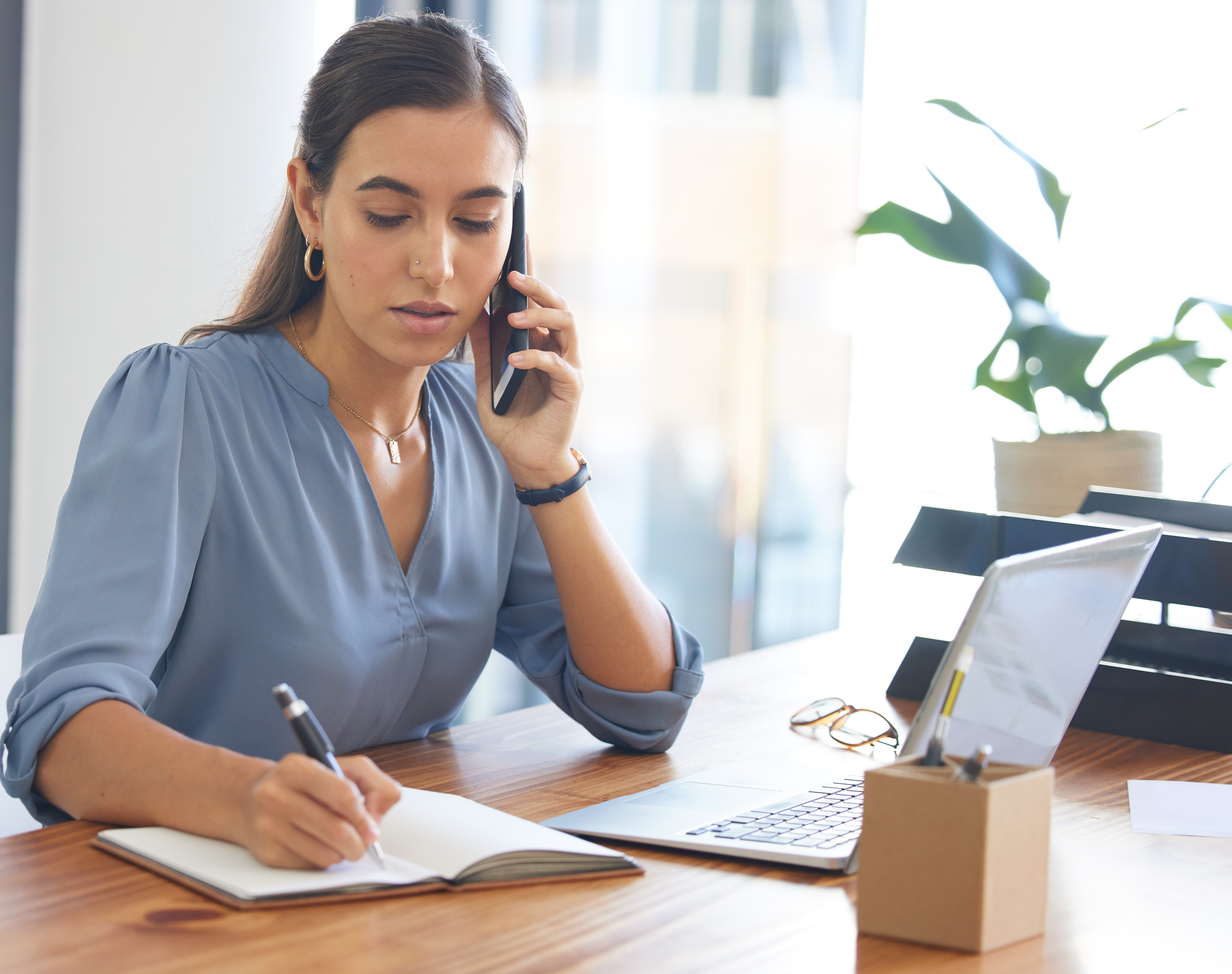 Female employee, assistant or administrator make notes. | Source: Shutterstock