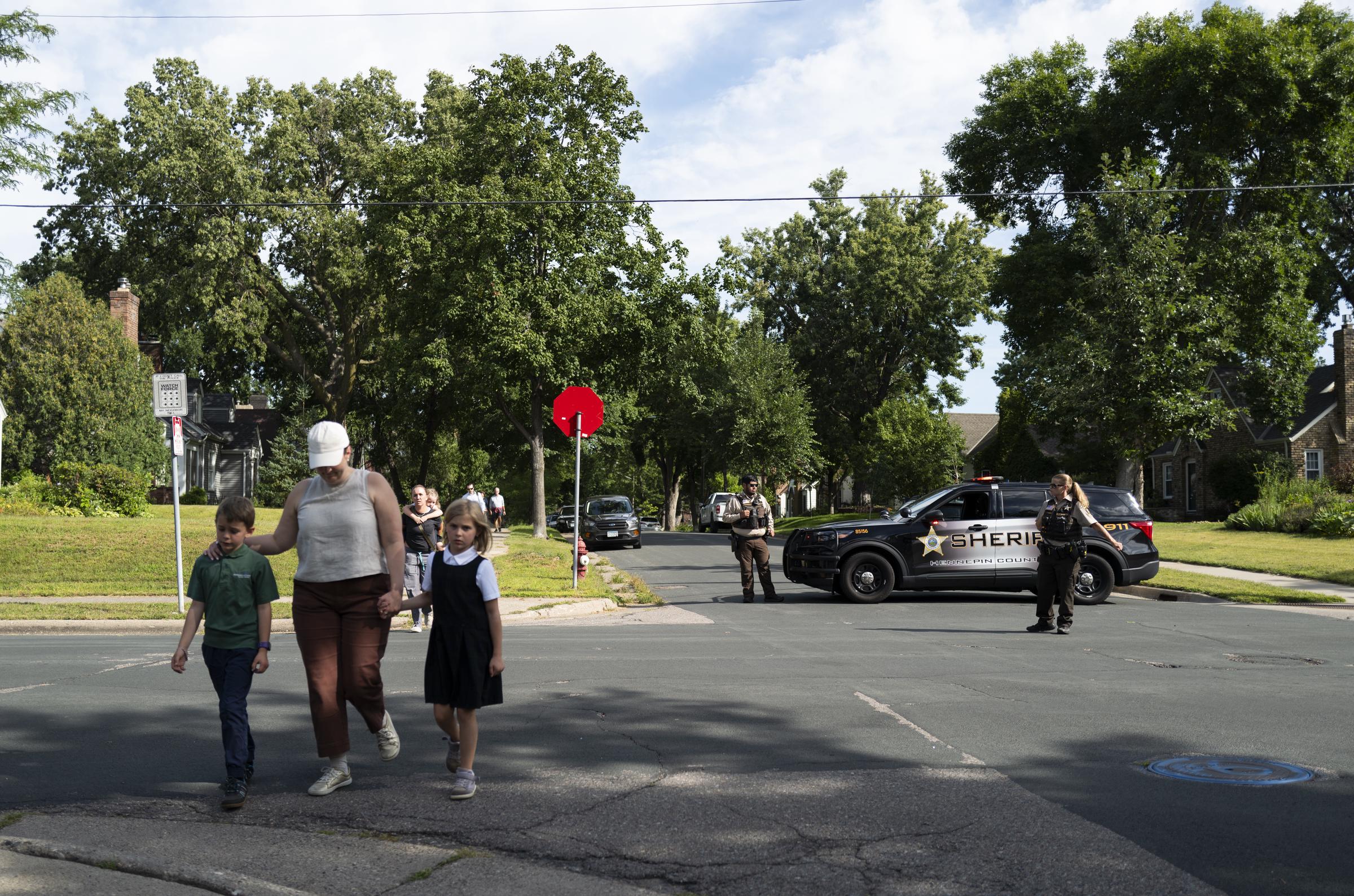 Families walk with children away from Annunciation Church after the shooting during a school Mass in Minneapolis on August 27, 2025 | Source: Getty Images