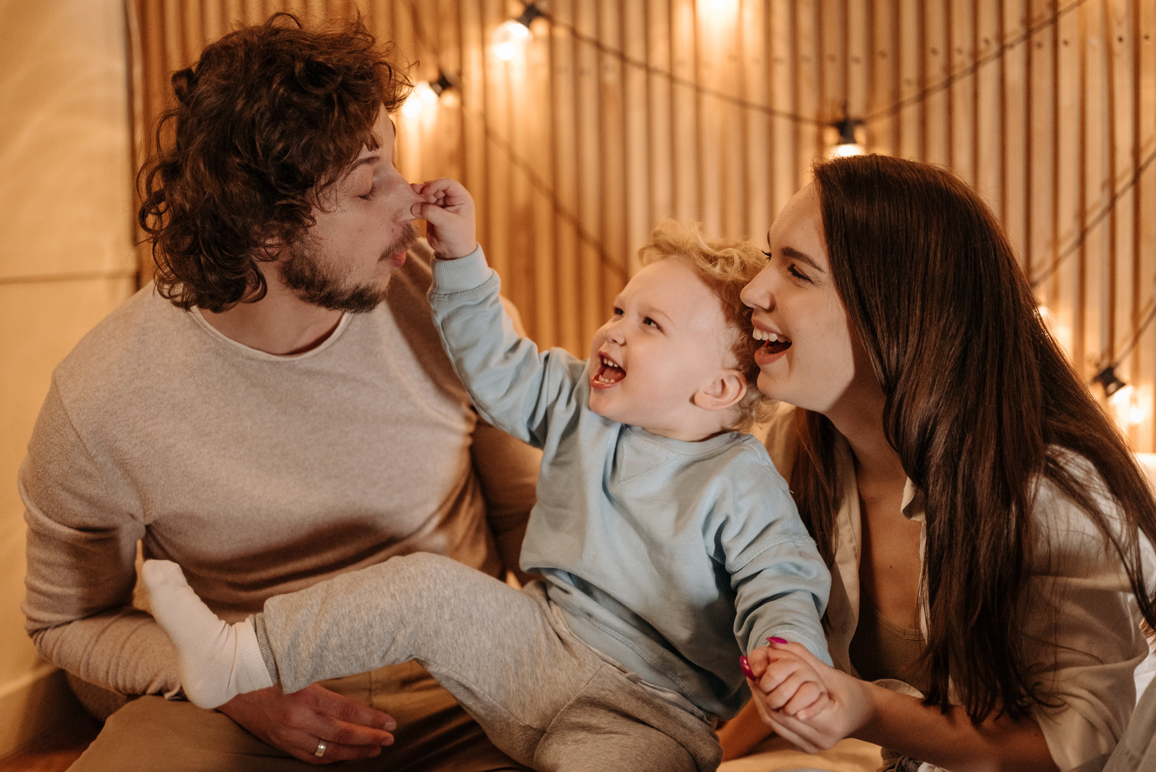 A couple playing with their child | Source: Pexels