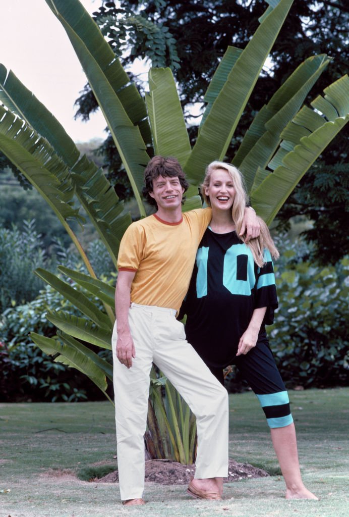Portrait of couple, English Rock musician Mick Jagger and American model Jerry Hall, as they pose together during a vacation on the island of Barbados, 1983. | Photo: Getty Images