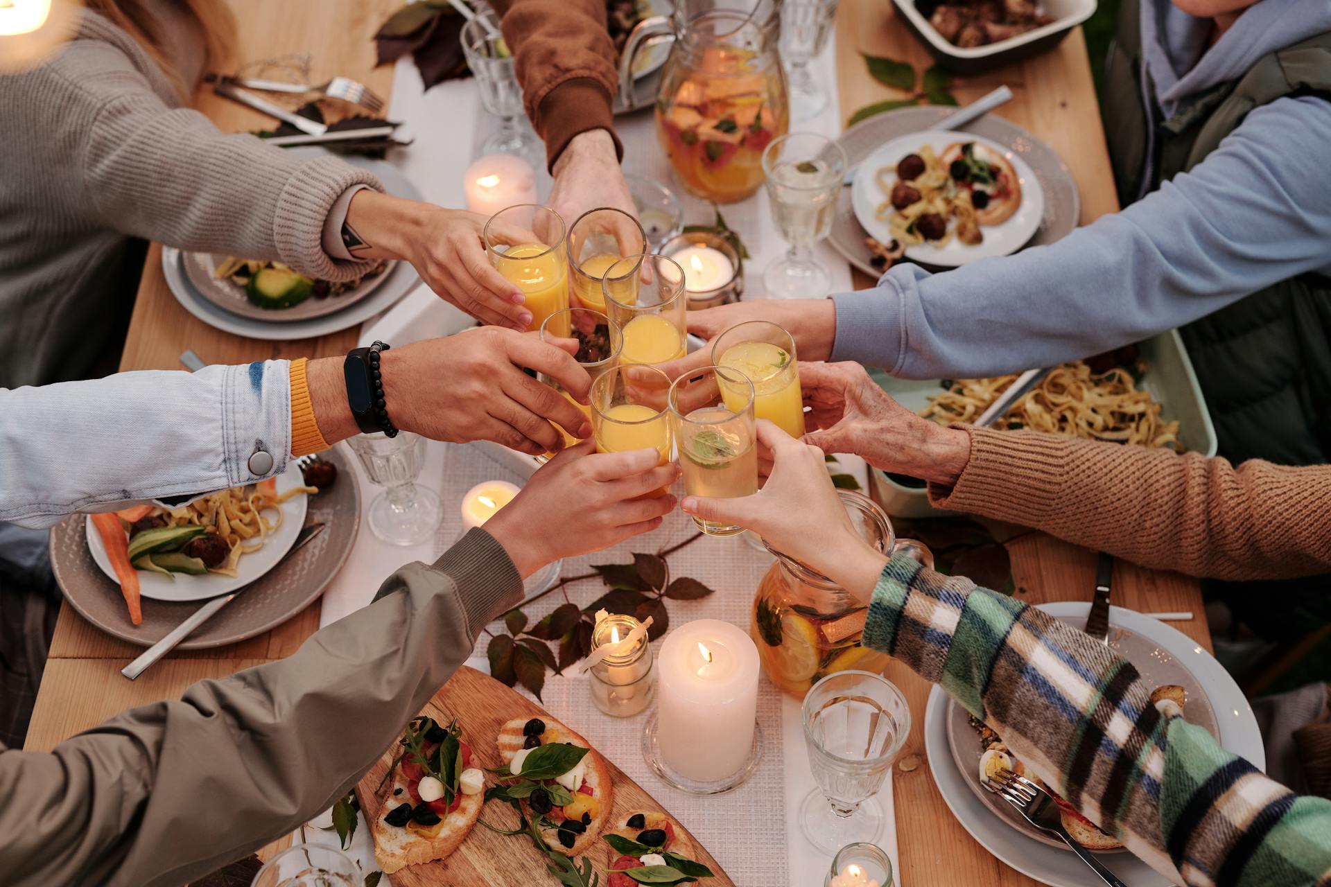A close-up photo of family members toasting at dinner | Source: Pexels