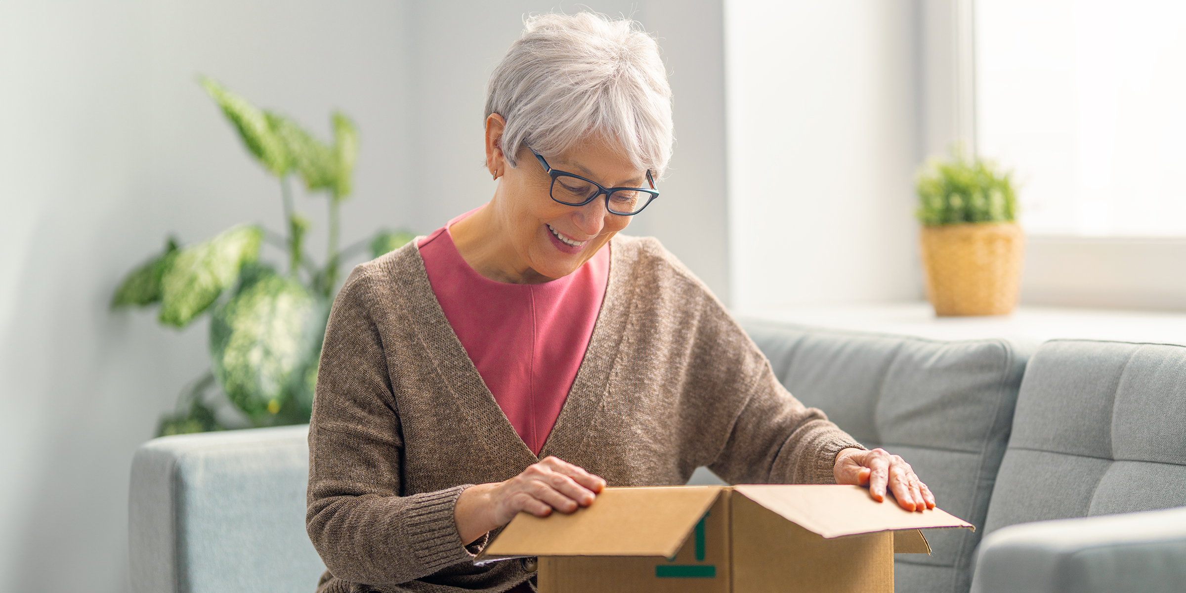An old woman opening a box | Source: Shutterstock