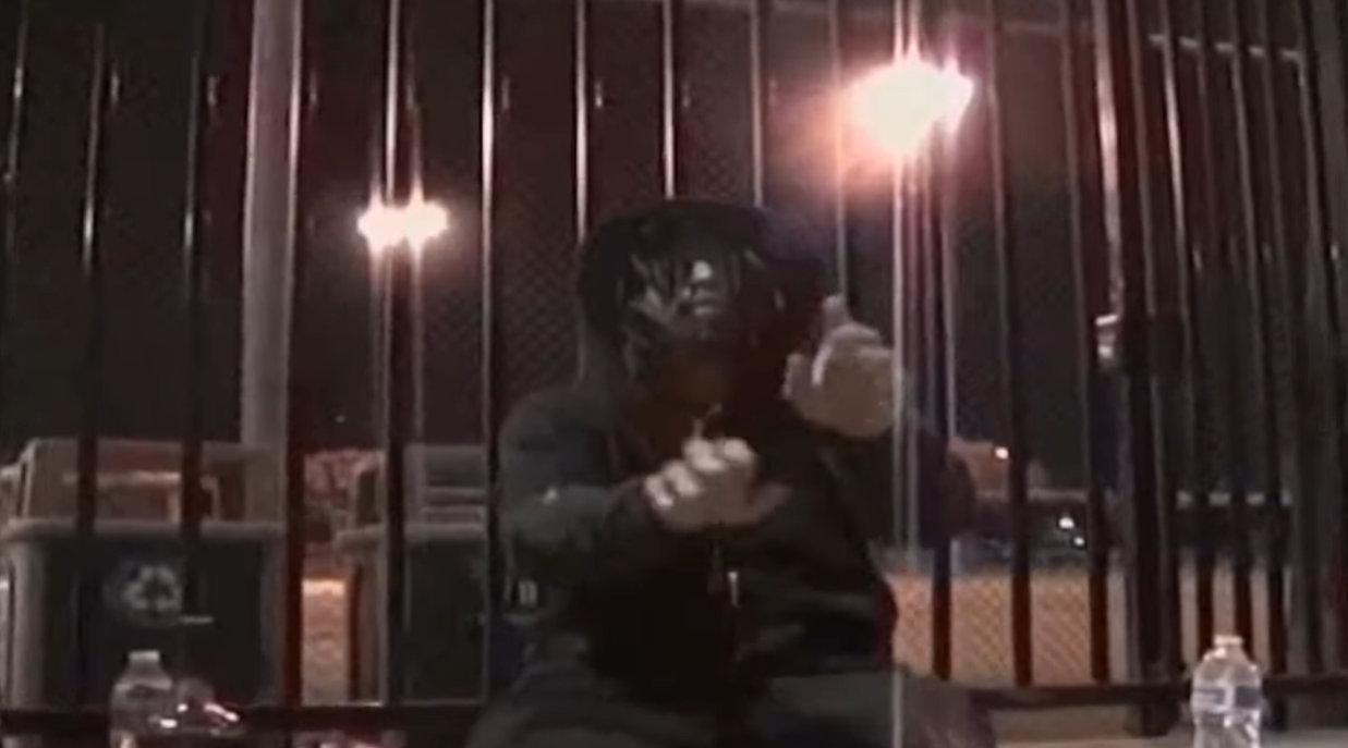 Luci4 appears in a dark, nighttime setting in a scene from one of his music videos, as posted in December 2024 | Source: Youtube/ogvamp1