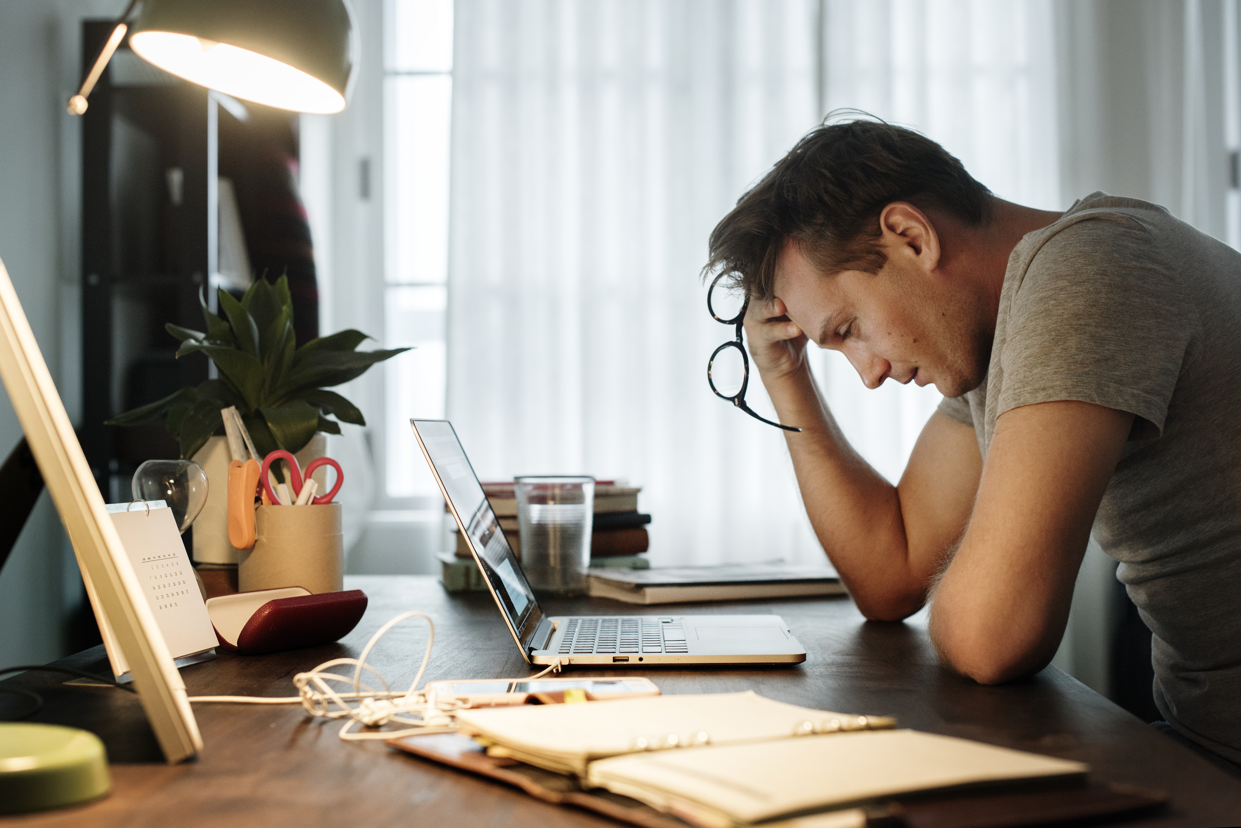 Man stressed while working on laptop | Source: Getty Images