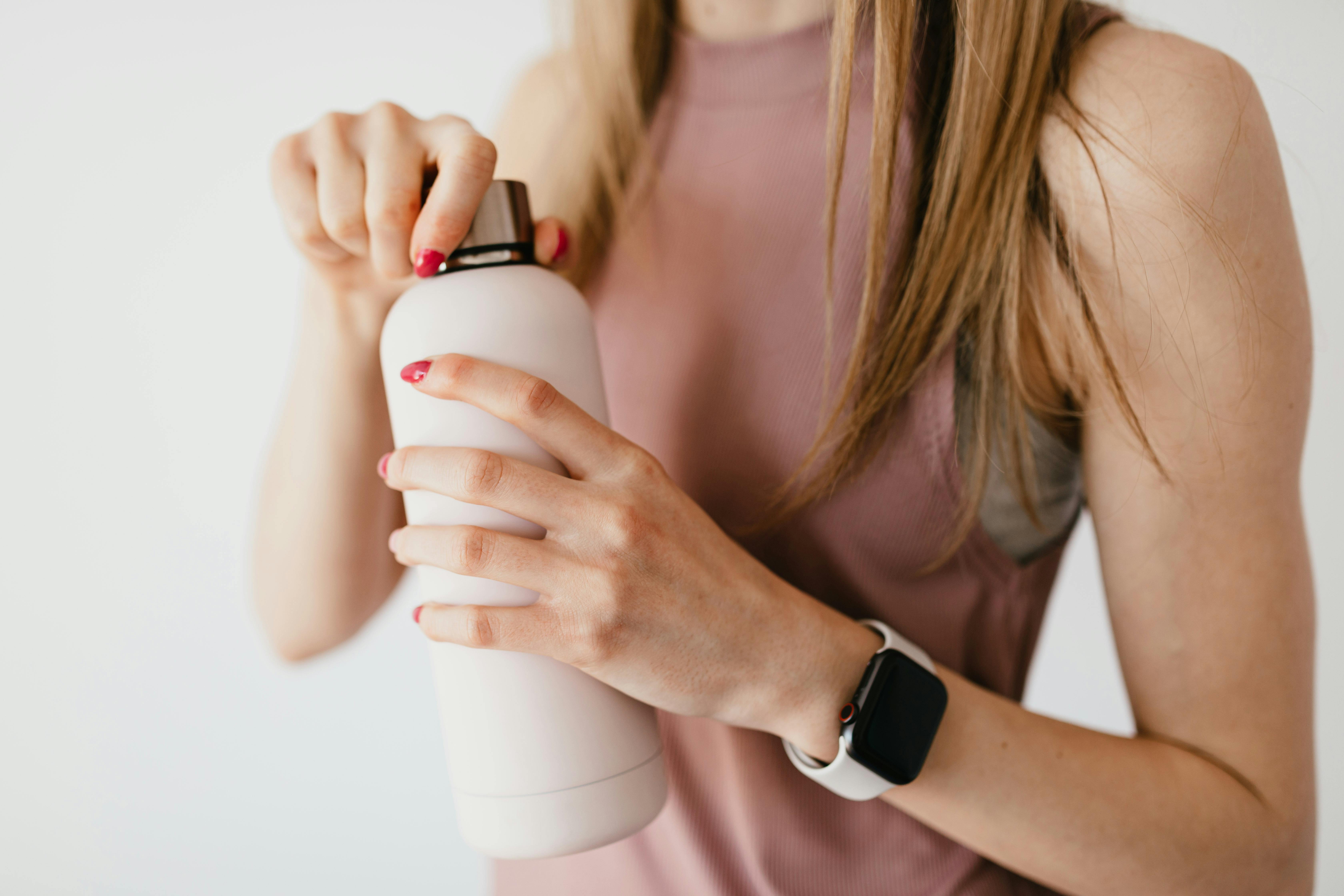 A woman holding a water bottle. | Source: Pexels