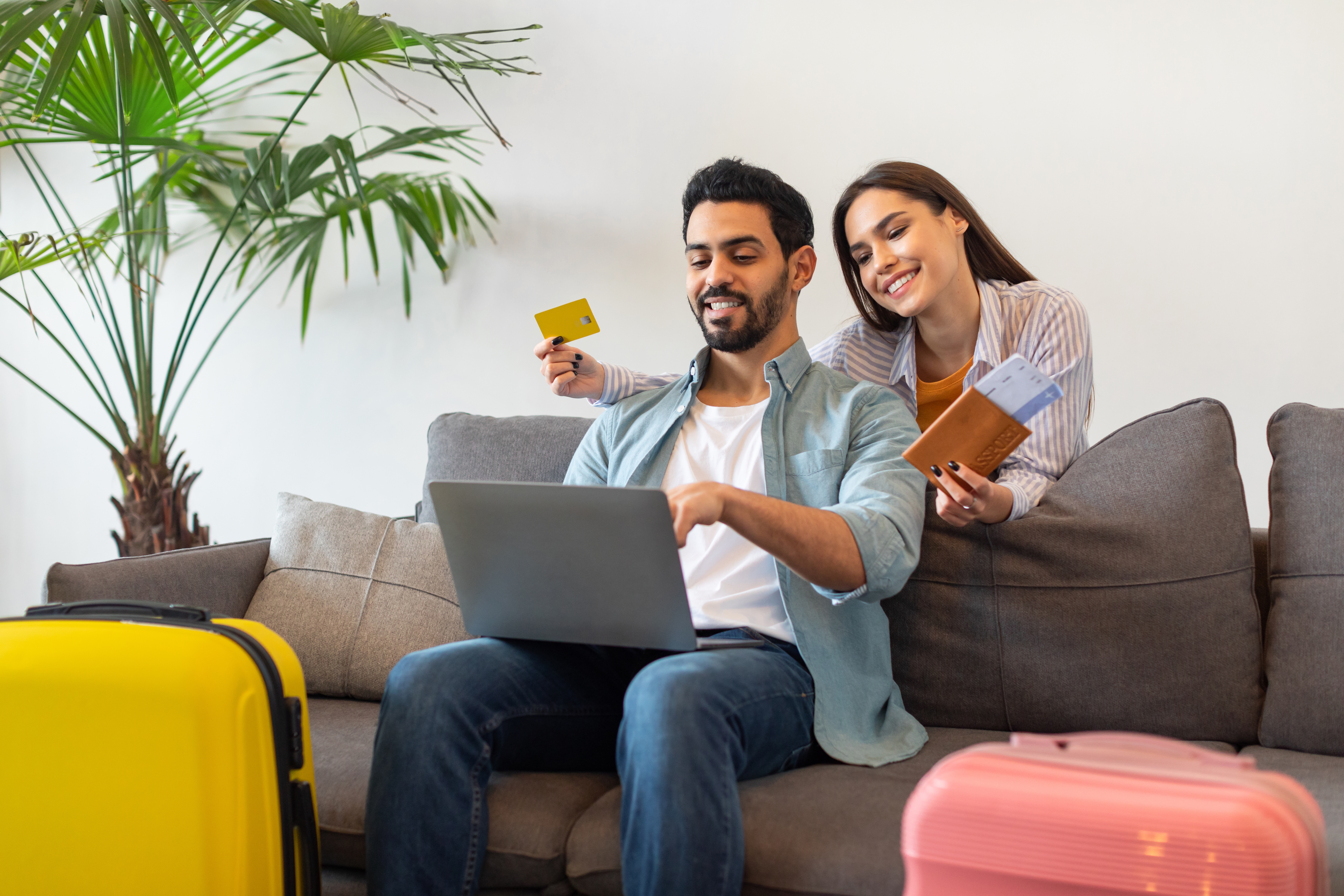 A couple excited to book a holiday | Source: Shutterstock