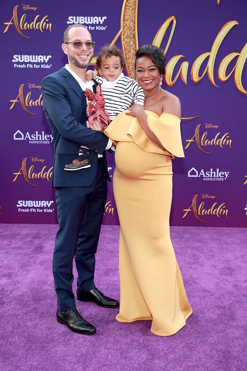Dr. Vaughn Rasberry, Edward Rasberry, and Tatyana Ali attending the premiere of Disney's "Aladdin" at El Capitan Theatre in Los Angeles, California in May 2019. I Image: Getty Images.