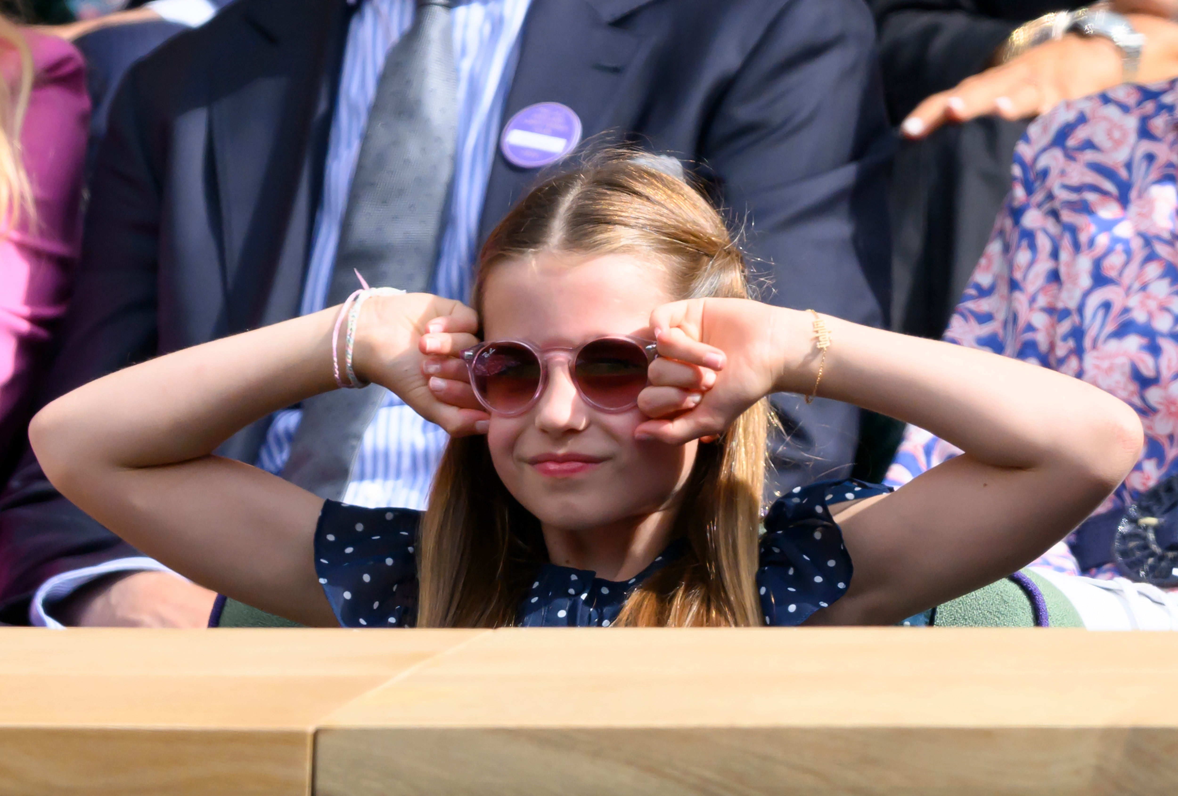 Princess Charlotte shielding her face with her fists while attending the men's final at Wimbledon in London on July 14, 2024 | Source: Getty Images