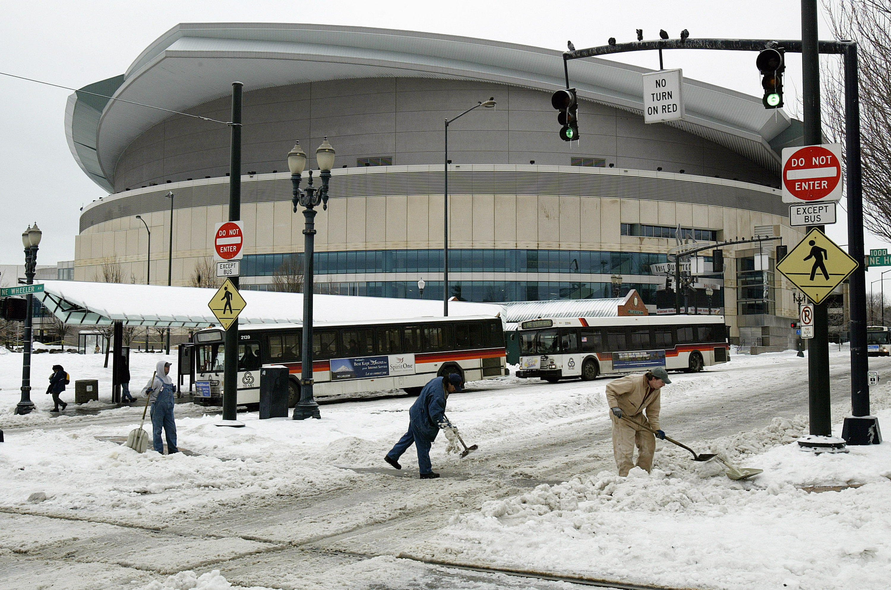 Tri-Met workers clear ice and snow near the Rose Garden in Portland, Oregon | Source: Getty Images