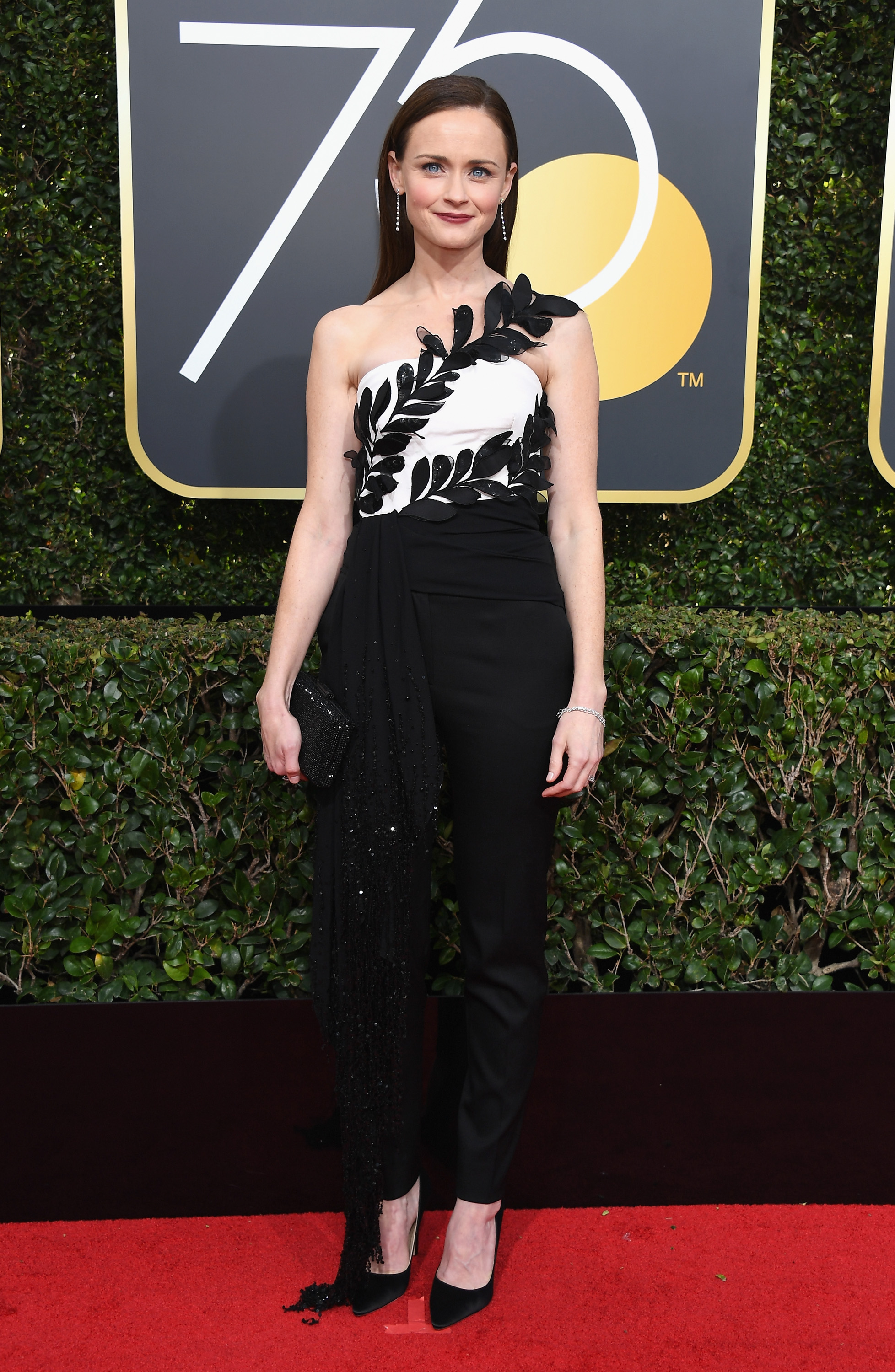 By 2018, Bledel had fully transformed into a red carpet regular, turning heads at the Golden Globe Awards. Wearing a structured black-and-white gown with leaf appliqués and sleek, straight hair, she exuded sophistication. The Emmy-winning actress had recently gained critical acclaim for her role in "The Handmaid's Tale," marking a major shift from her early teen drama roots.
