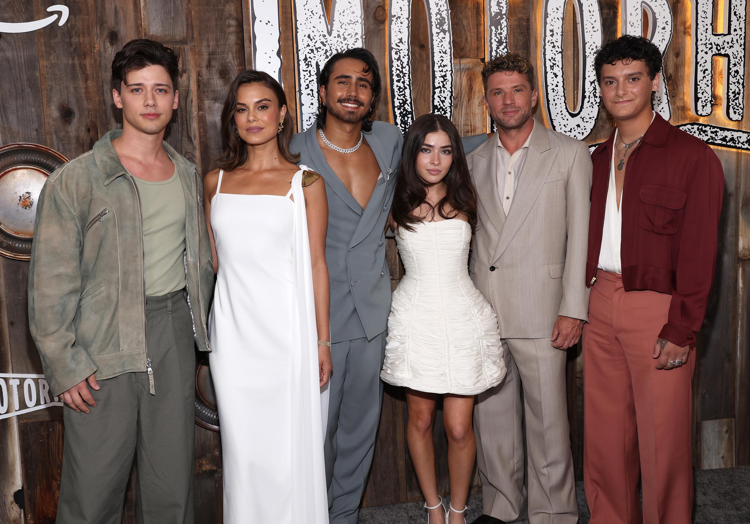 Uriah Shelton, Nathalie Kelley, Michael Cimino, Melissa Collazo, Ryan Phillippe, and Nicolas Cantu stand for a cast photo at the "Motorheads" premiere, dressed in coordinated tones as they gather before the event's rustic backdrop.
