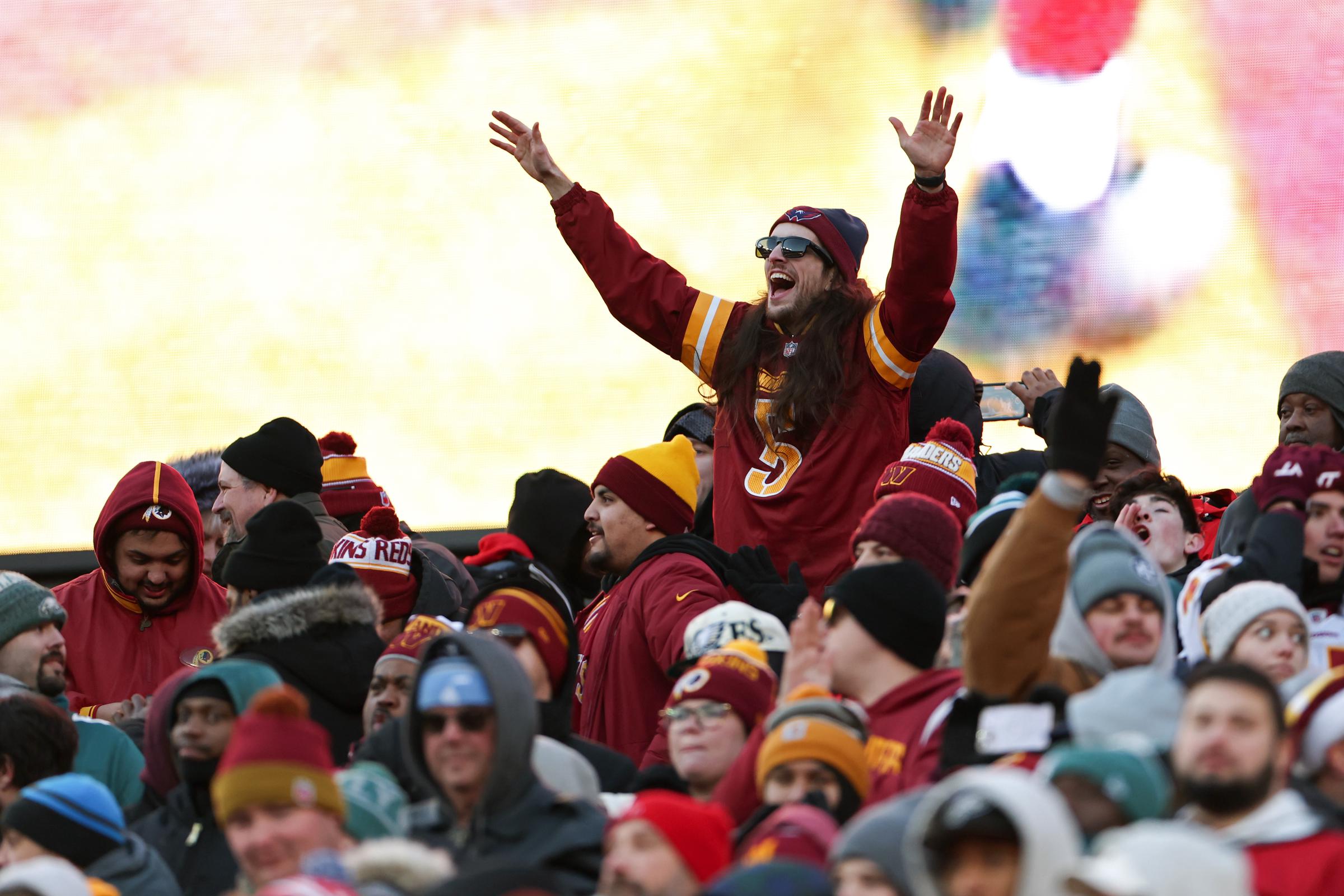 A fan cheers for the Washington Commanders at Northwest Stadium on December 22, 2024 | Source: Getty Images