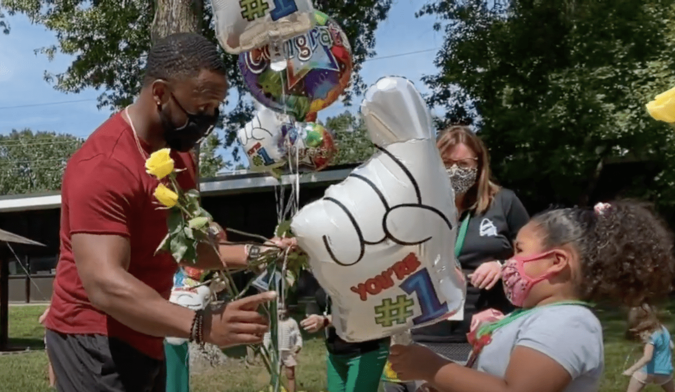 A student gives flowers to Darrion Cockrell who was named Lindbergh Teacher of the Year and 2021 Missouri Teacher of the Year in November, 2020. | Source: YouTube/LindberghSchools