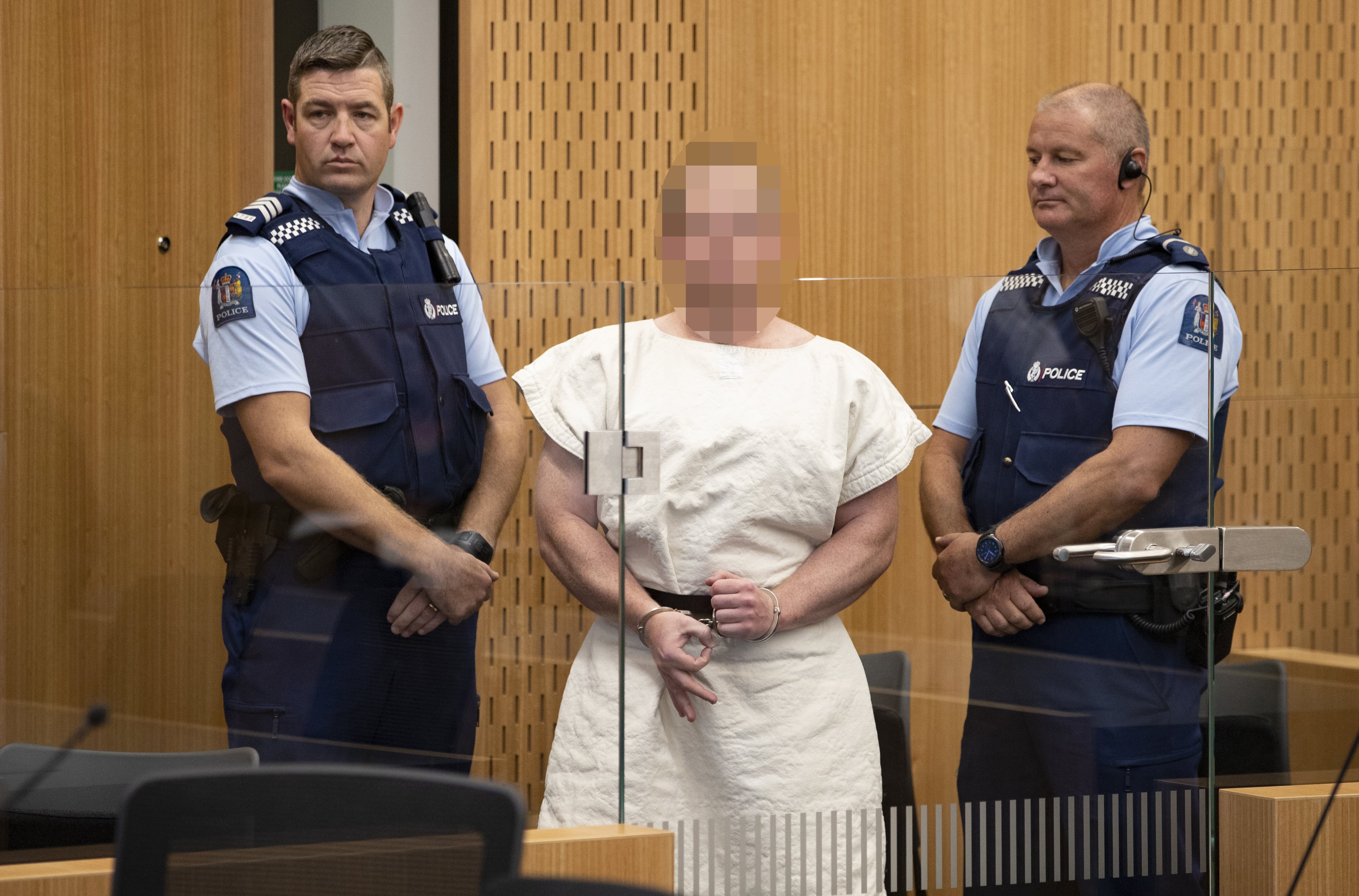 Brenton Tarrant doing the 'white power' symbol at the Christchurch District Court | Photo: Getty Images