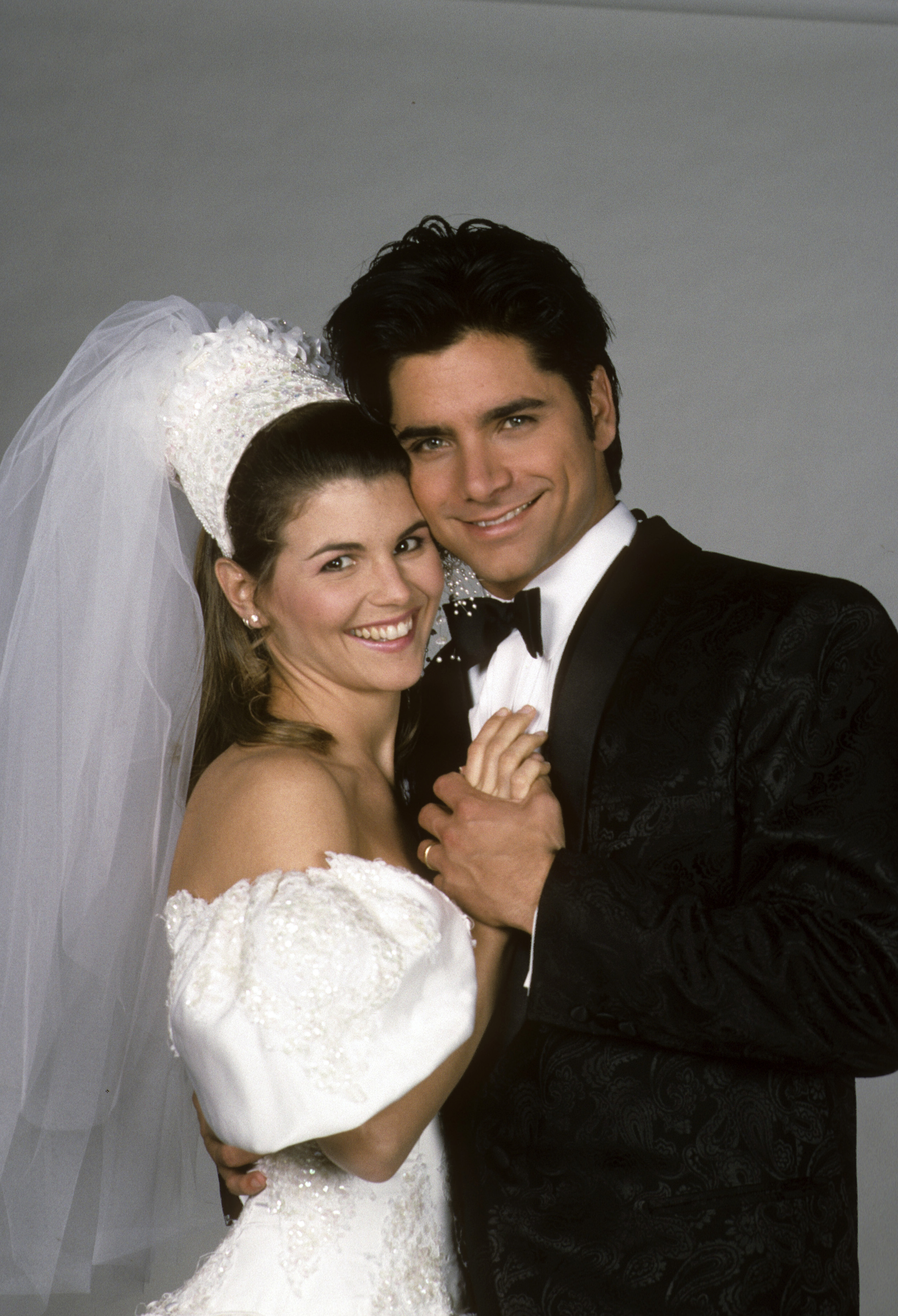 Lori Loughlin and co-star John Stamos were captured in a studio portrait for season four of the television series "Full House" in 1991, dressed in wedding attire as their on-screen characters.